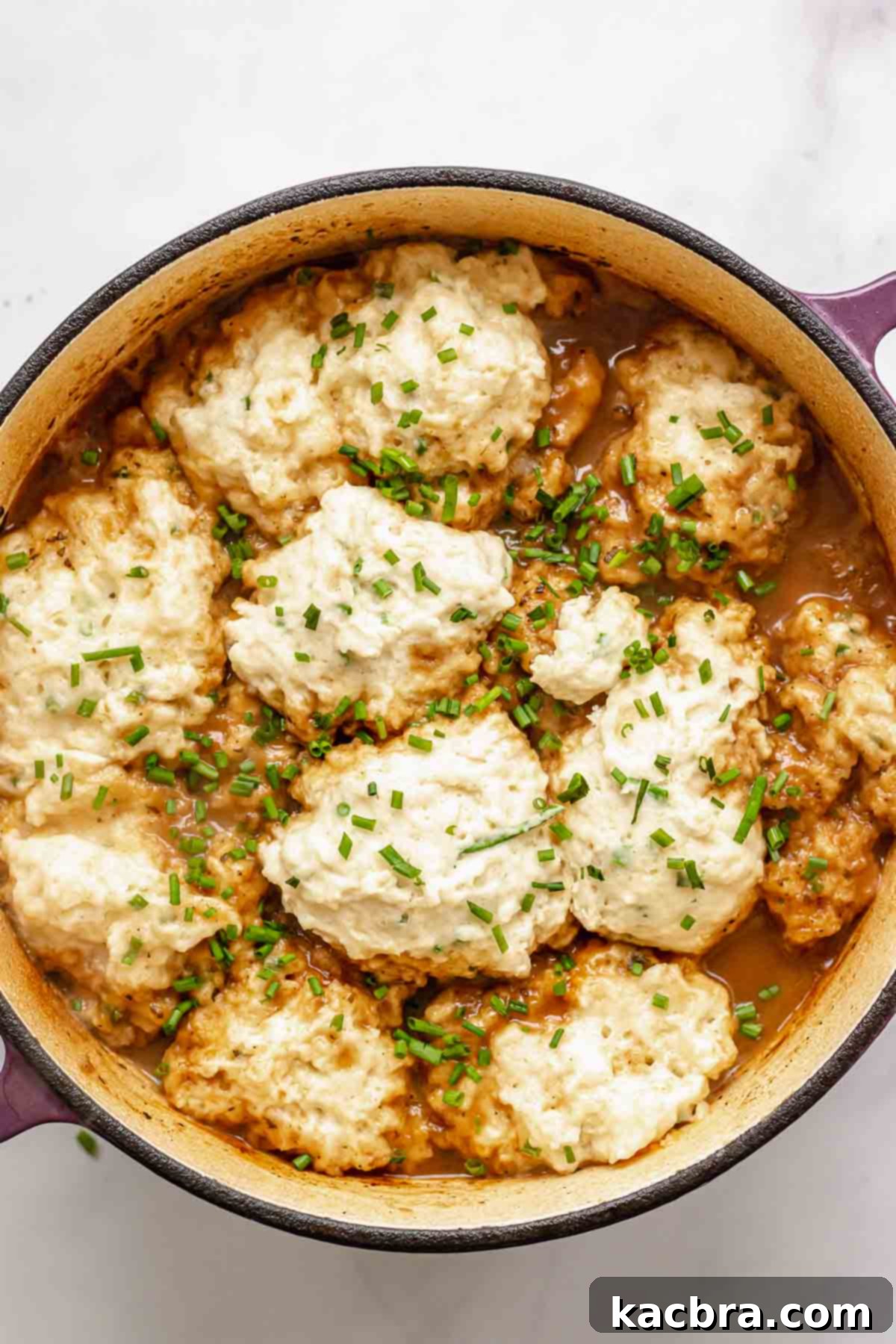 Chives on top of cooked, puffy dumplings.
