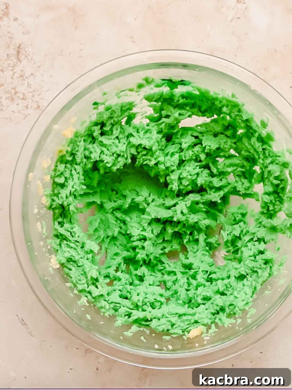 Green cookie dough in a bowl before flour is added.