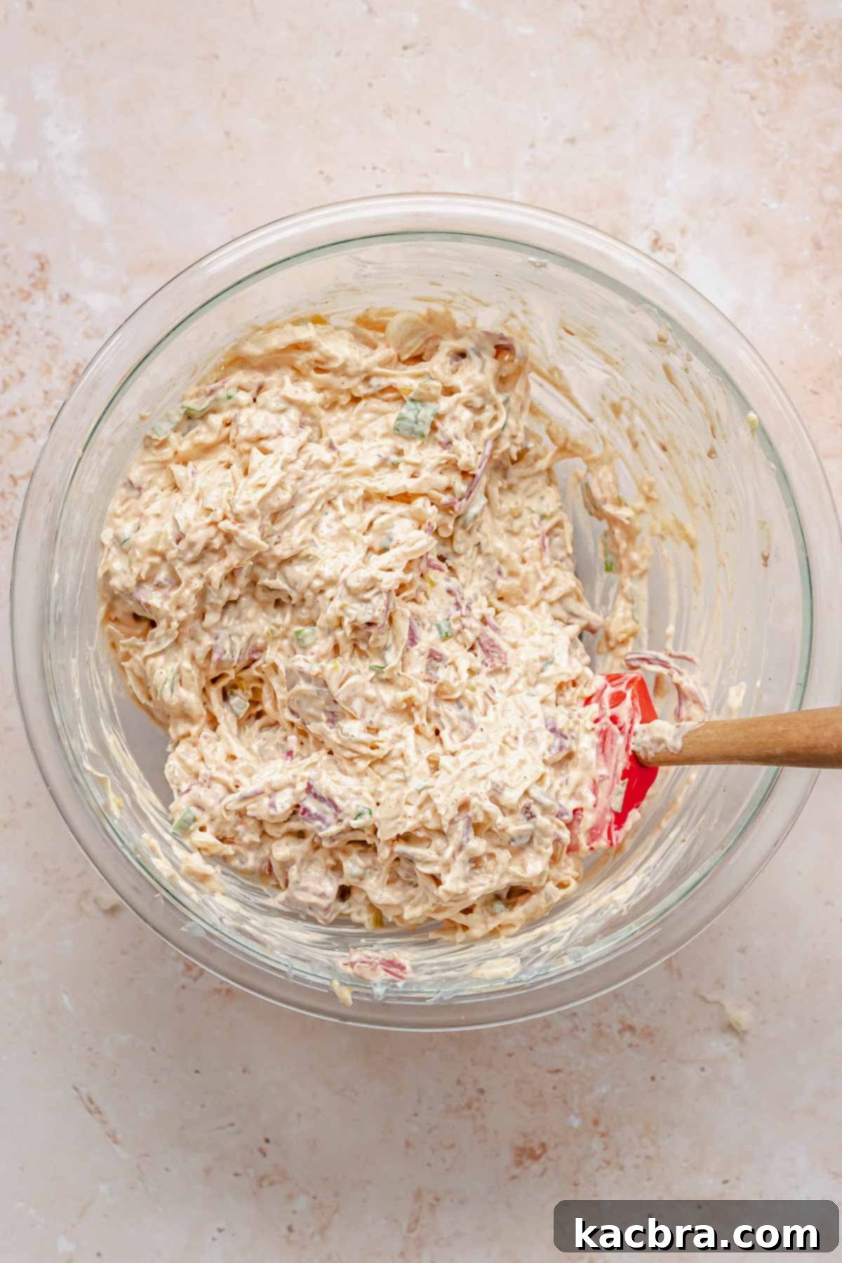 All dip ingredients mixed together in a bowl with a rubber spatula.
