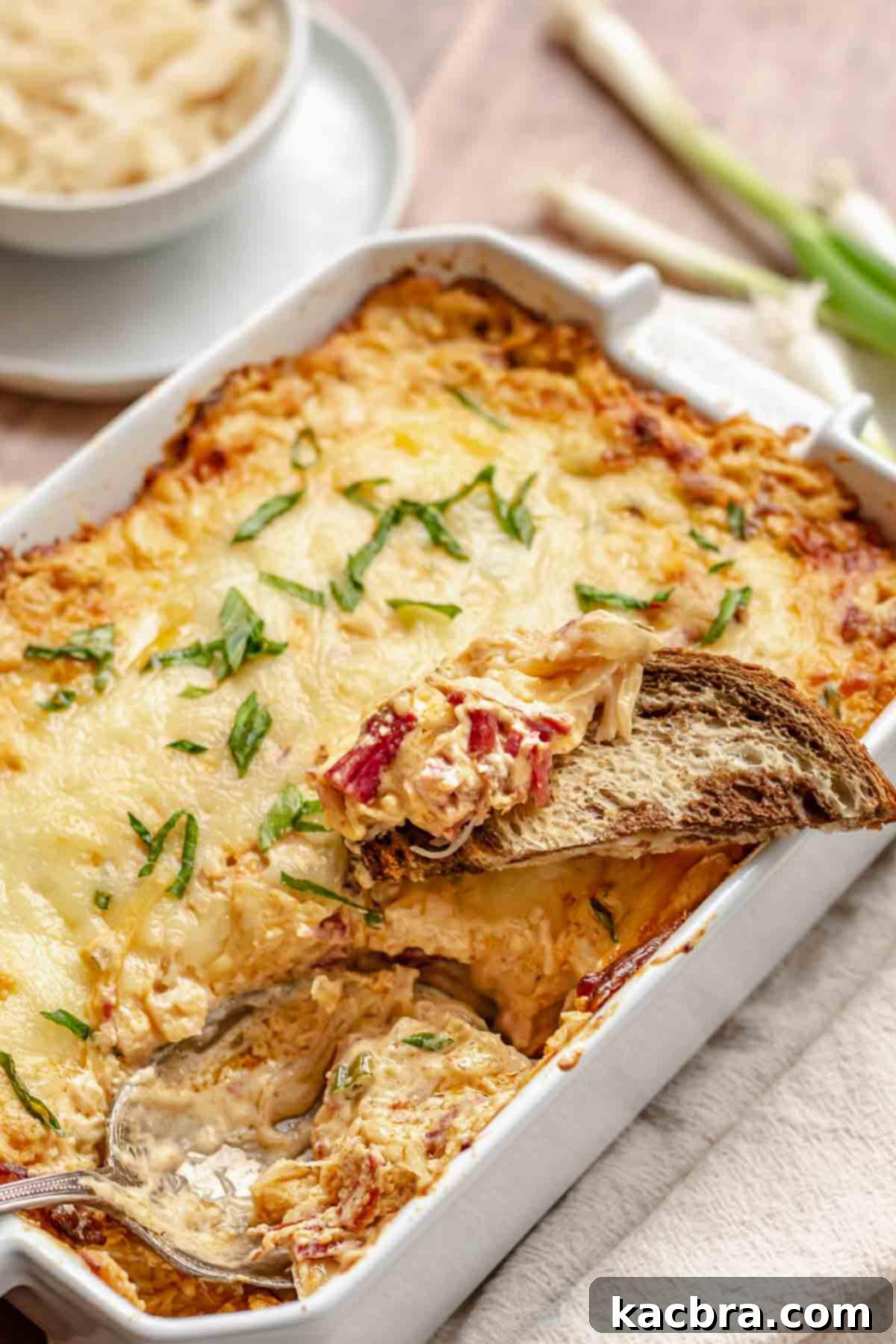 Reuben dip on a piece of bread resting on the dip.