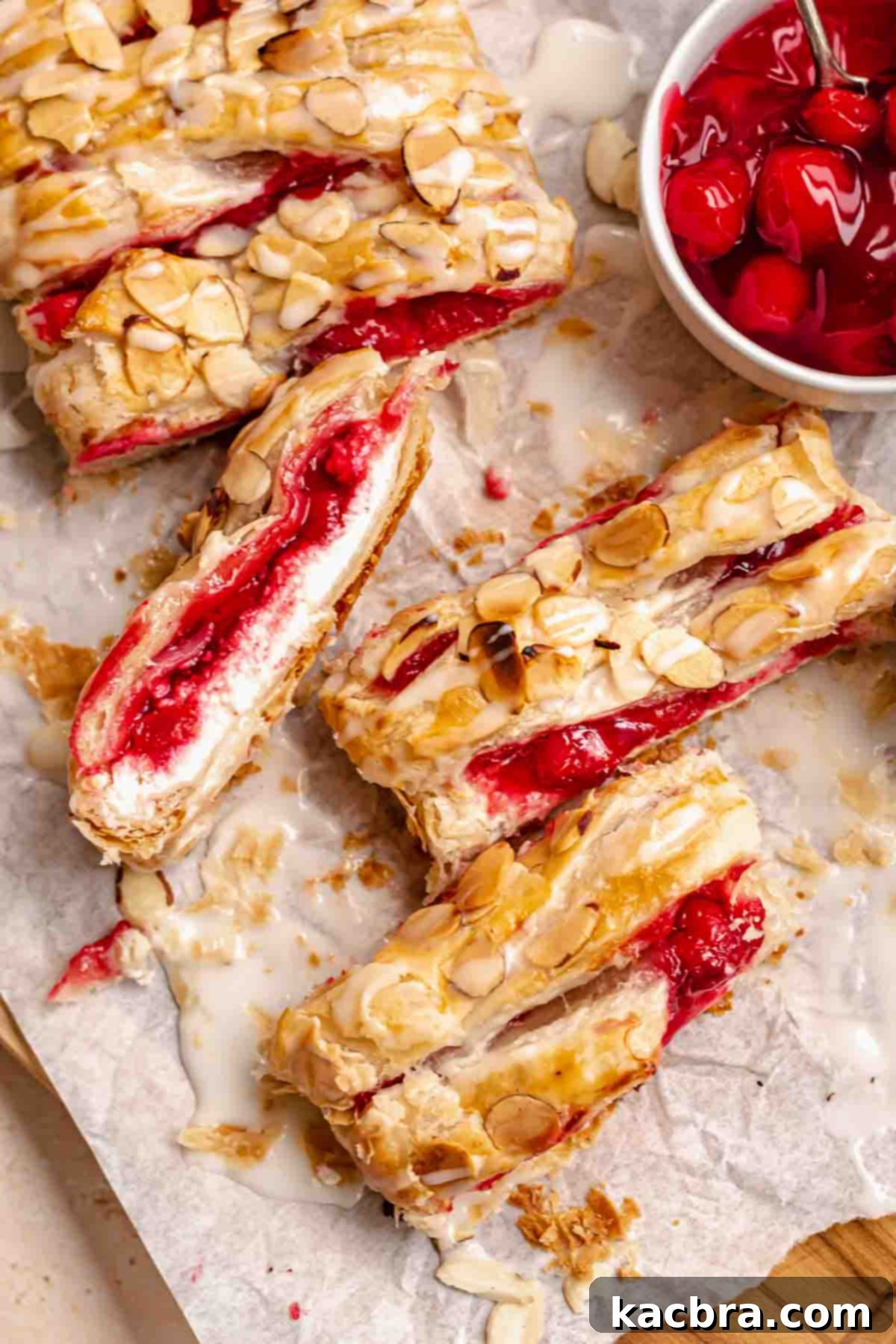Flaky Cherry Cream Cheese Pastry 2 Sliced cherry danish on a cutting board, showcasing its flaky layers and rich filling.