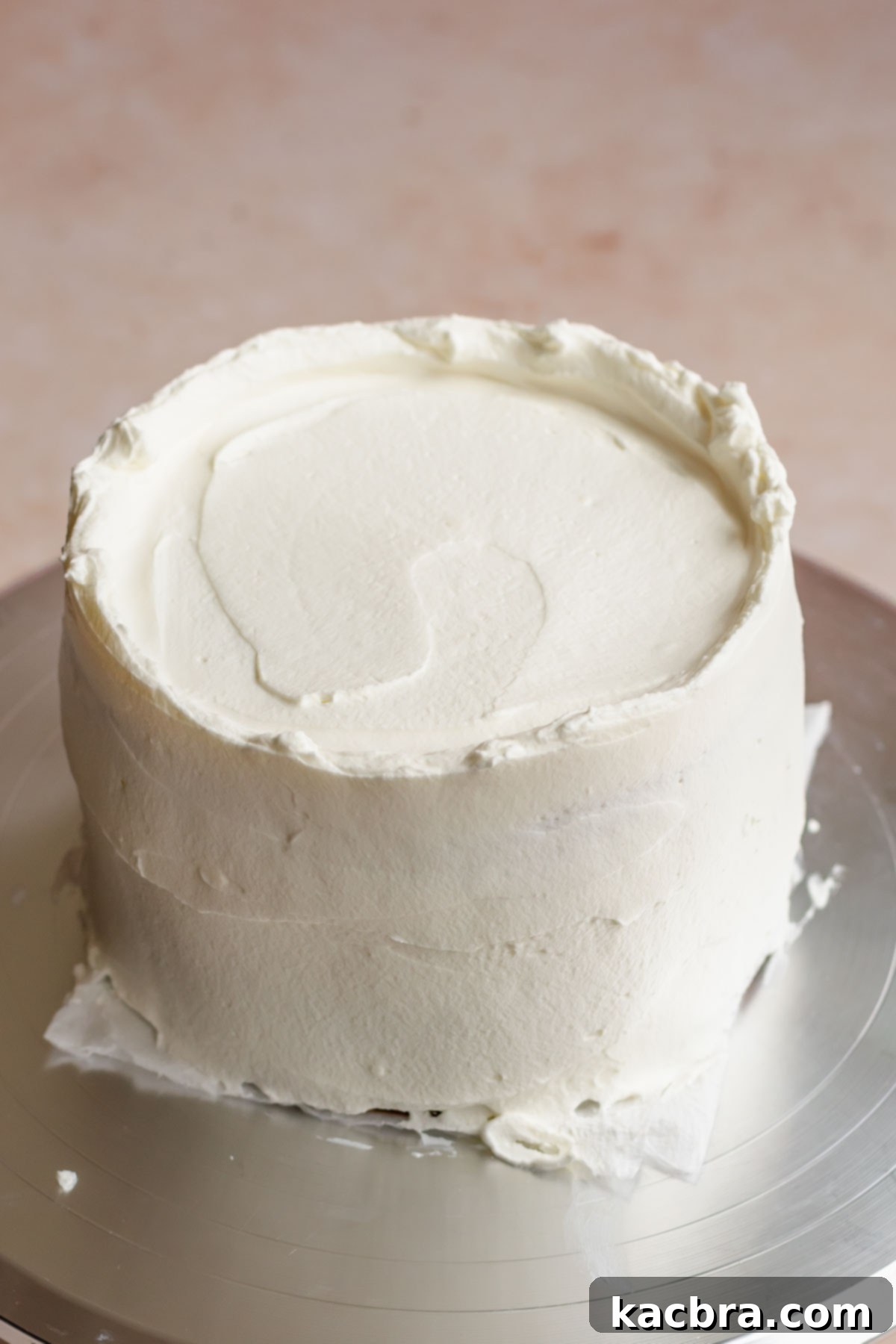 Crimson Kissed Almond Delight 17 A fully frosted cake, smoothed and ready for final decorations.