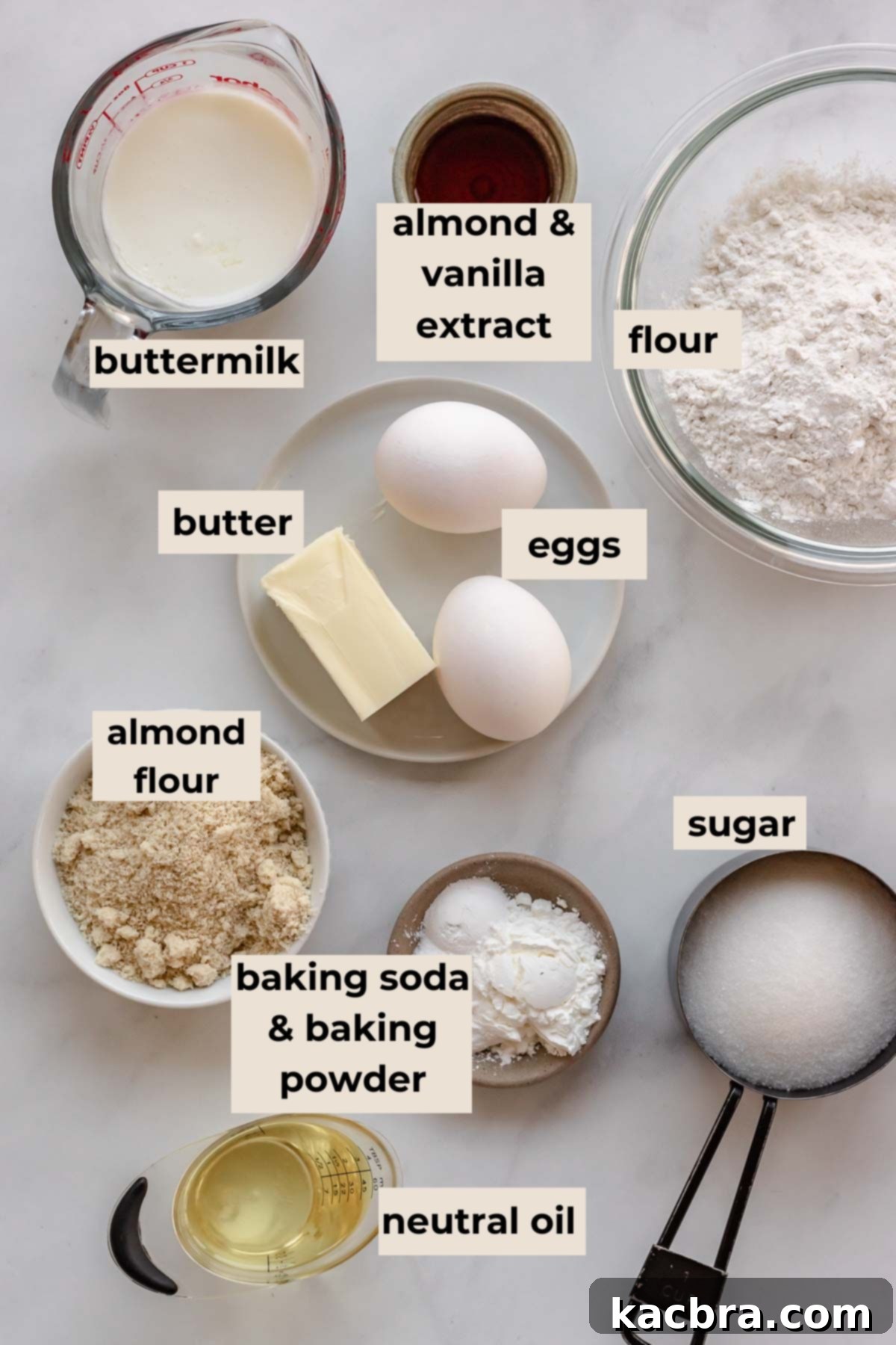 Crimson Kissed Almond Delight 3 A collection of dry and wet ingredients laid out for the almond cake, including flours, sugar, butter, and oil.