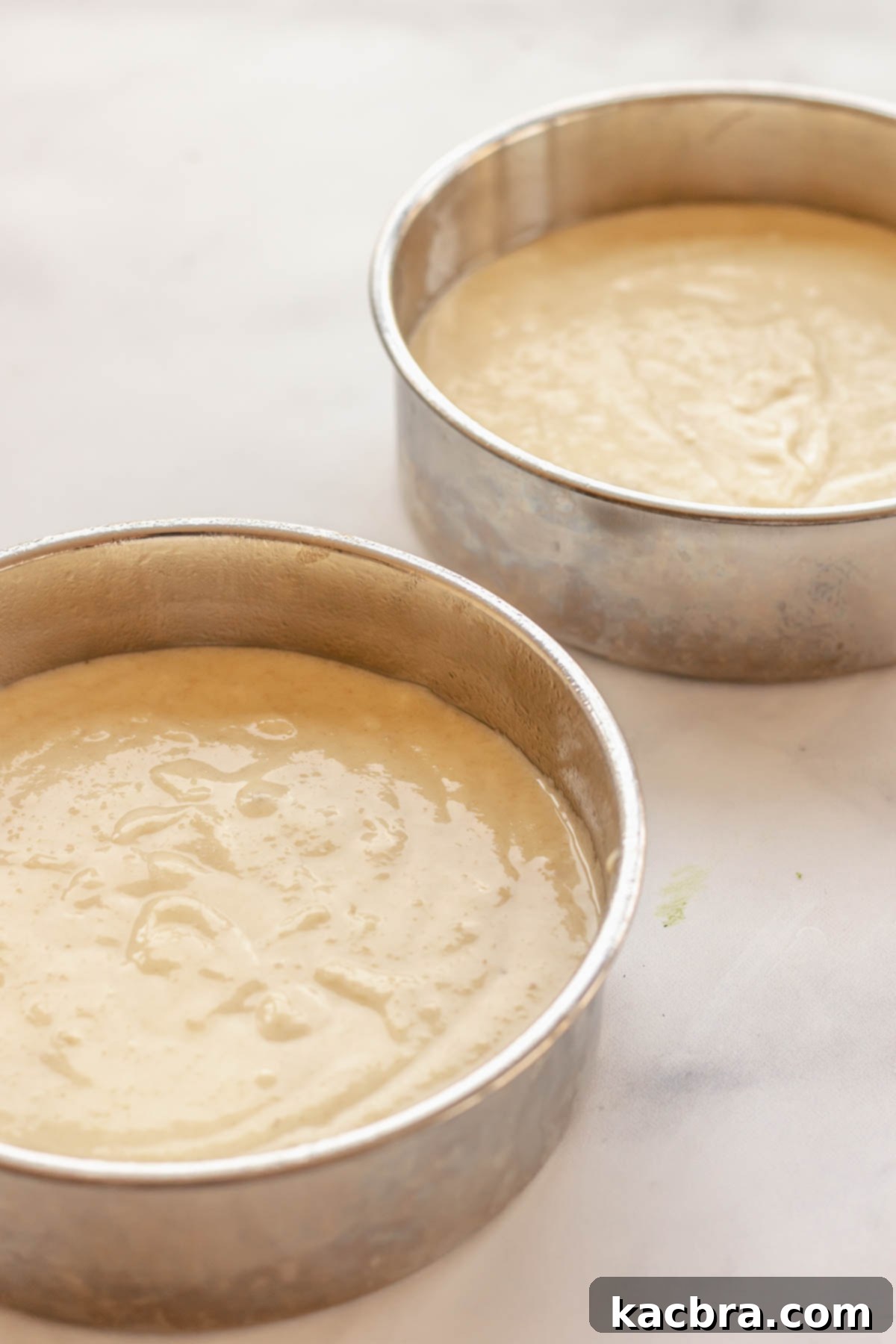 Crimson Kissed Almond Delight 9 Almond cake batter evenly divided into two 6-inch cake pans.