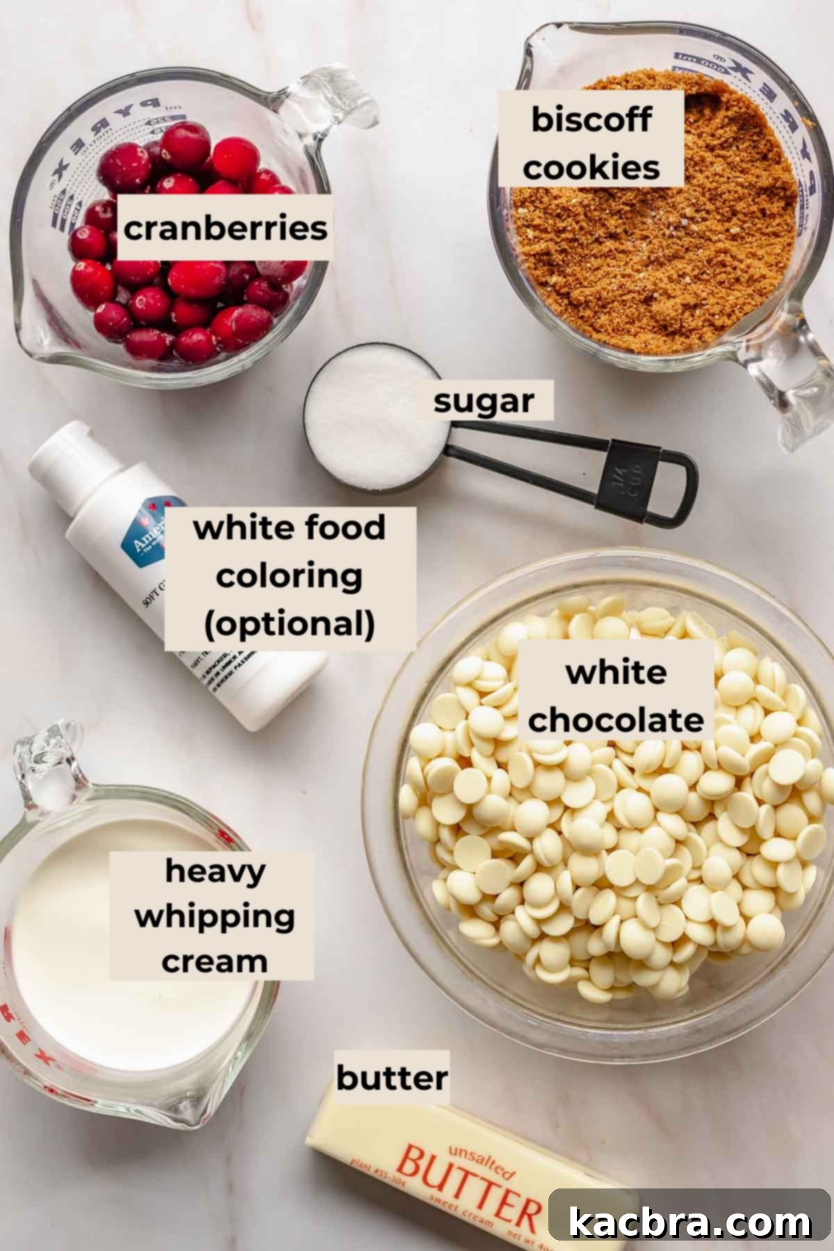 A selection of fresh cranberries, white chocolate callets, Biscoff cookies, sugar, and butter, neatly arranged for the cranberry white chocolate tart recipe.