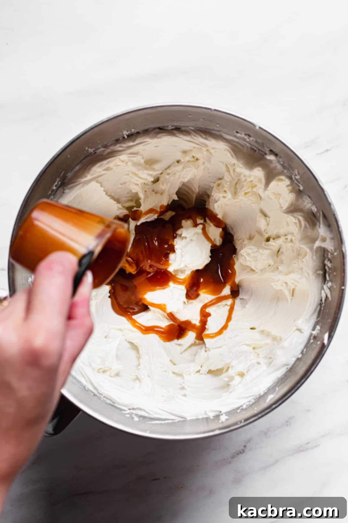 Salted Caramel Chocolate Indulgence 8 Caramel being poured into the buttercream