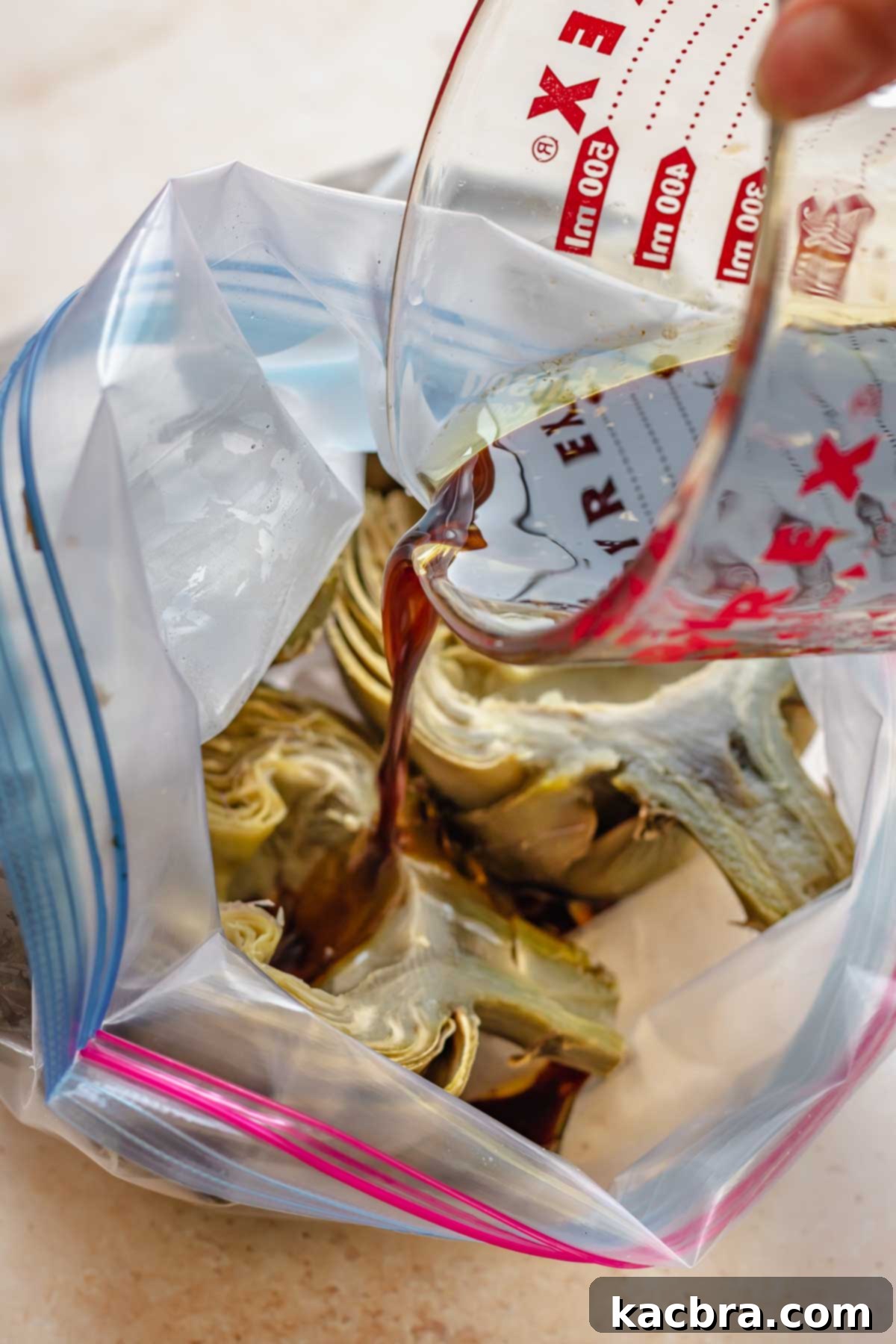 Marinade is poured into a bag of steamed artichoke halves.