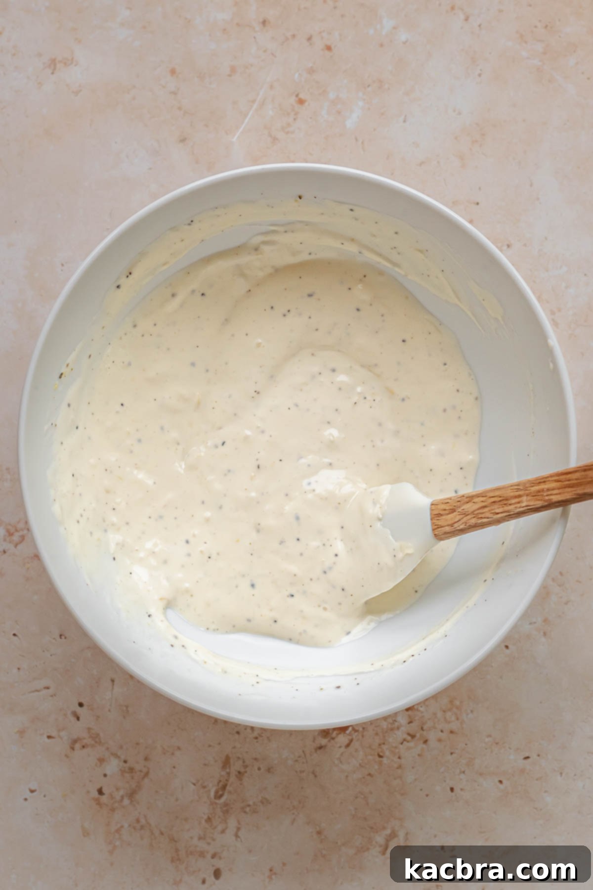 Mixed lemon aioli ingredients in a bowl.