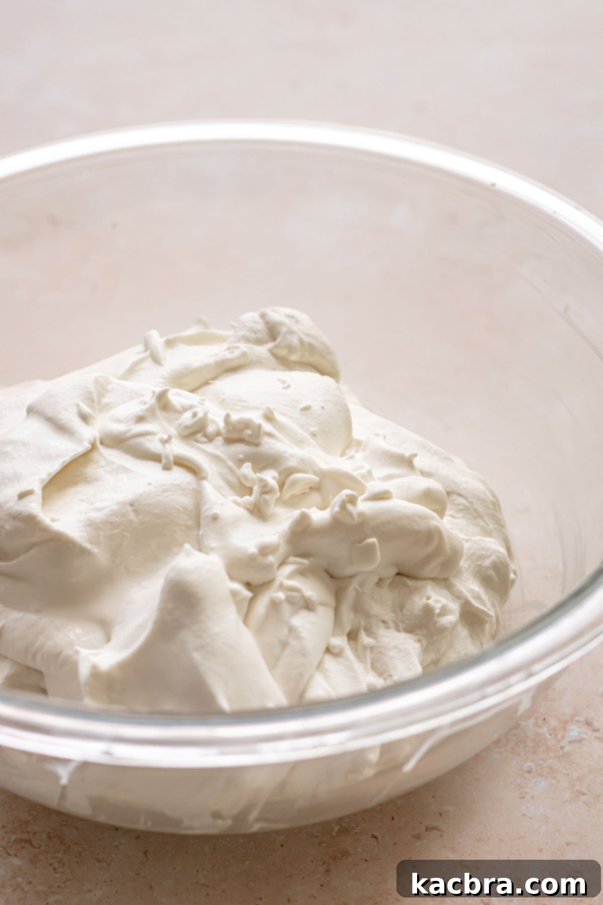 Creamy whipped cream in a bowl, ready for topping.