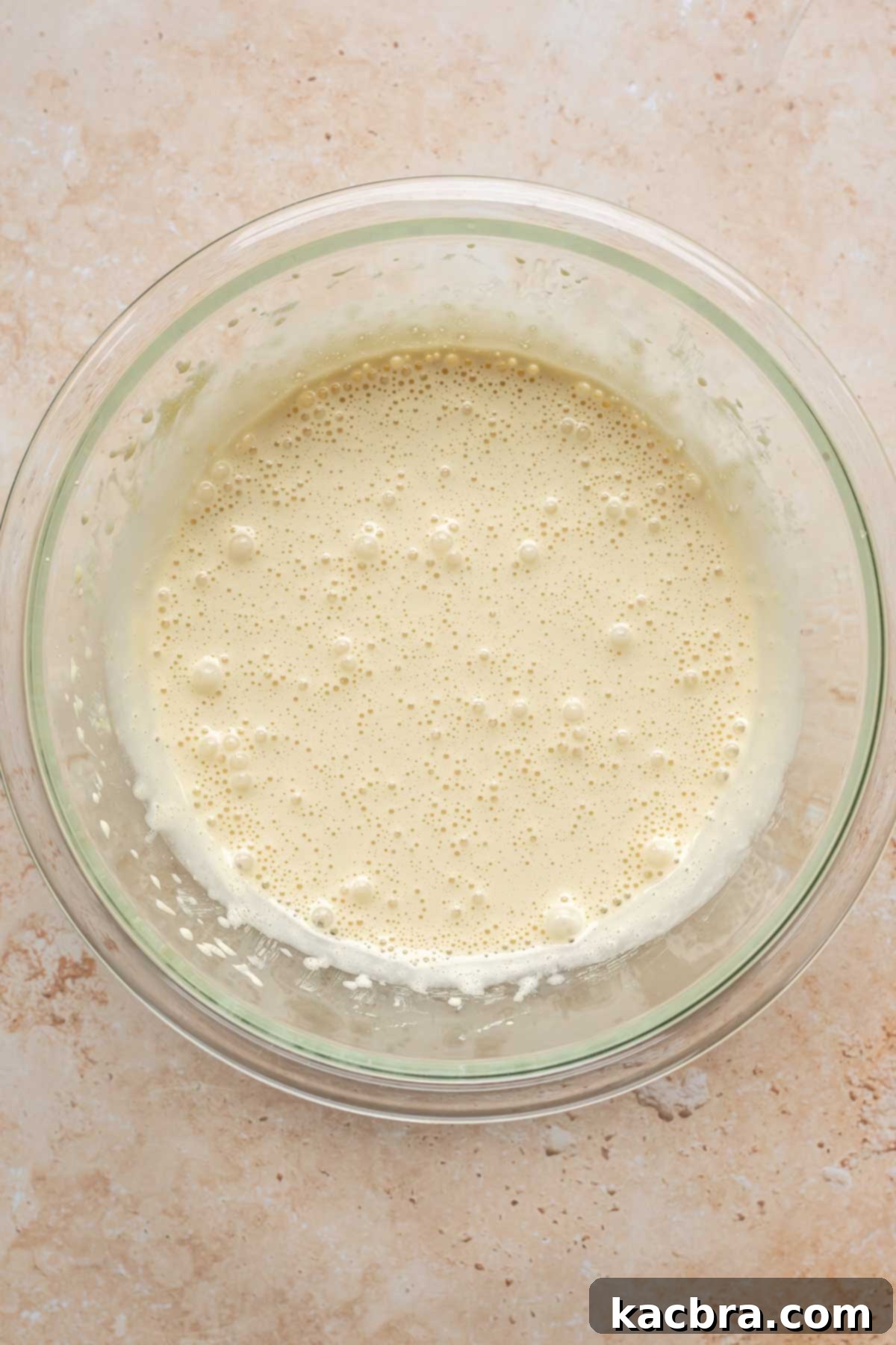 Sponge cake batter in a bowl, light and airy.