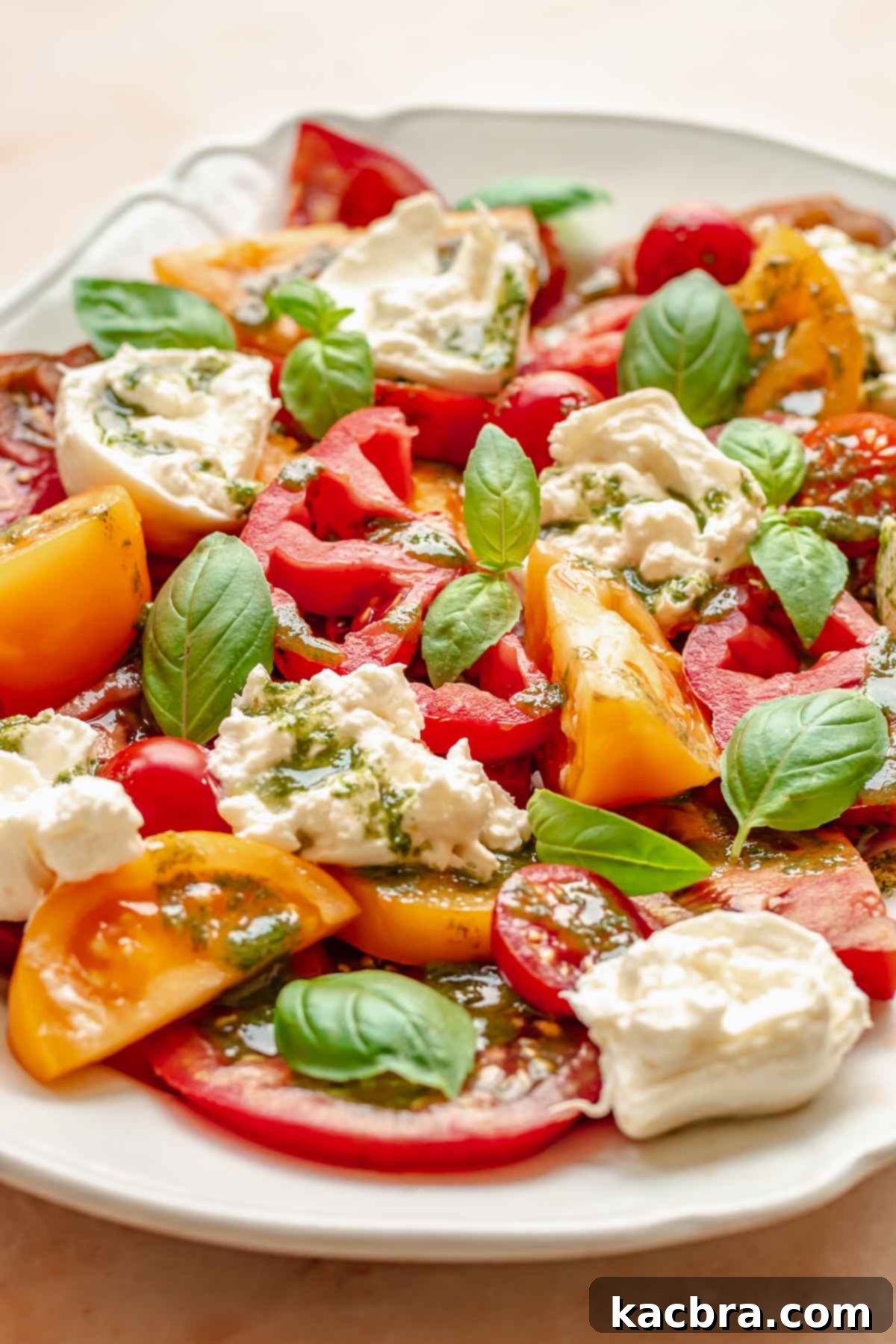 Fresh Burrata Caprese Drizzled with Aromatic Garlic Basil Oil 9 Fully garnished caprese salad on a platter.