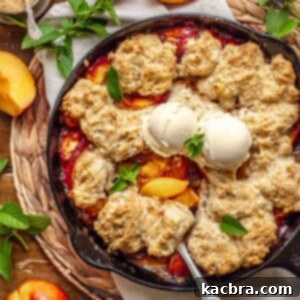 Golden Skillet Peach Cobbler 13 Skillet peach cobbler with a serving spoon in it.