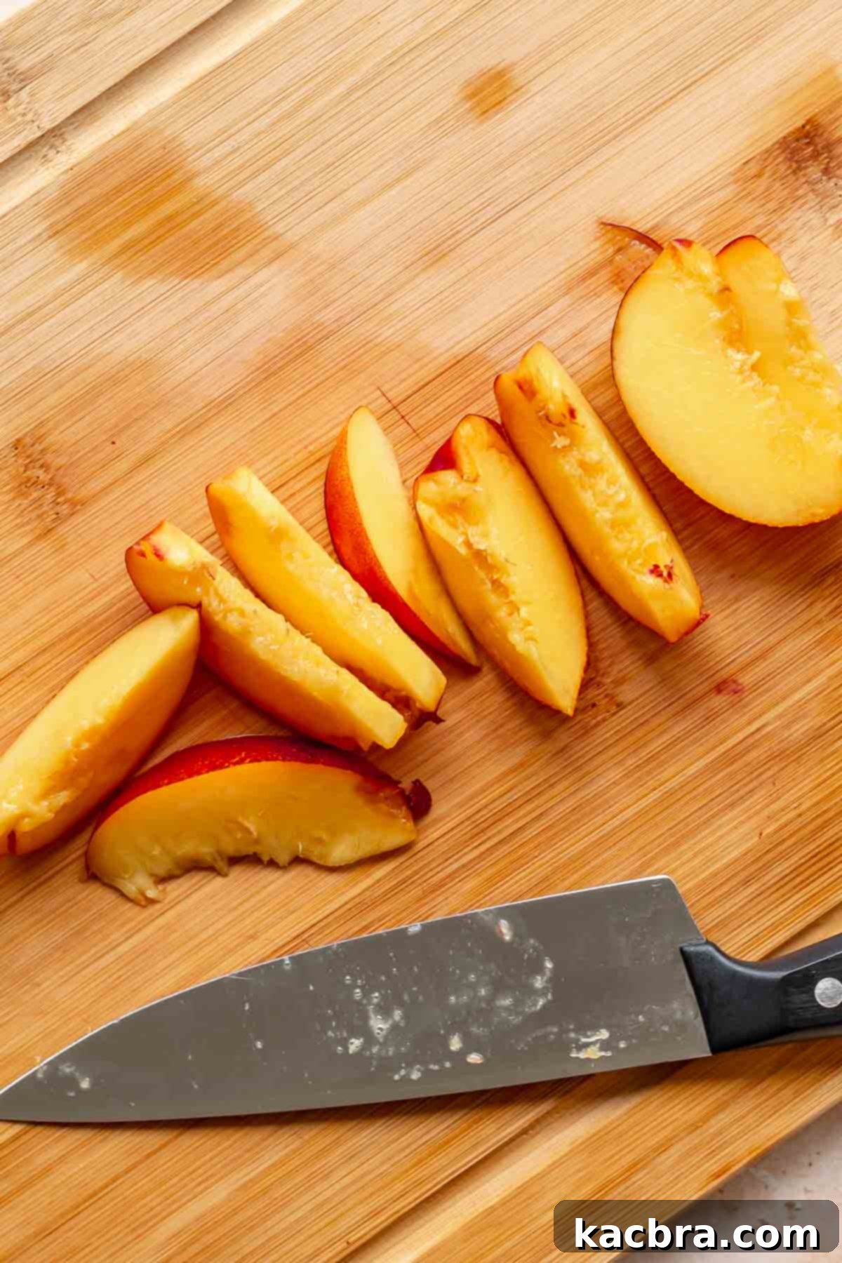Golden Skillet Peach Cobbler 4 Peach slices on a cutting board.