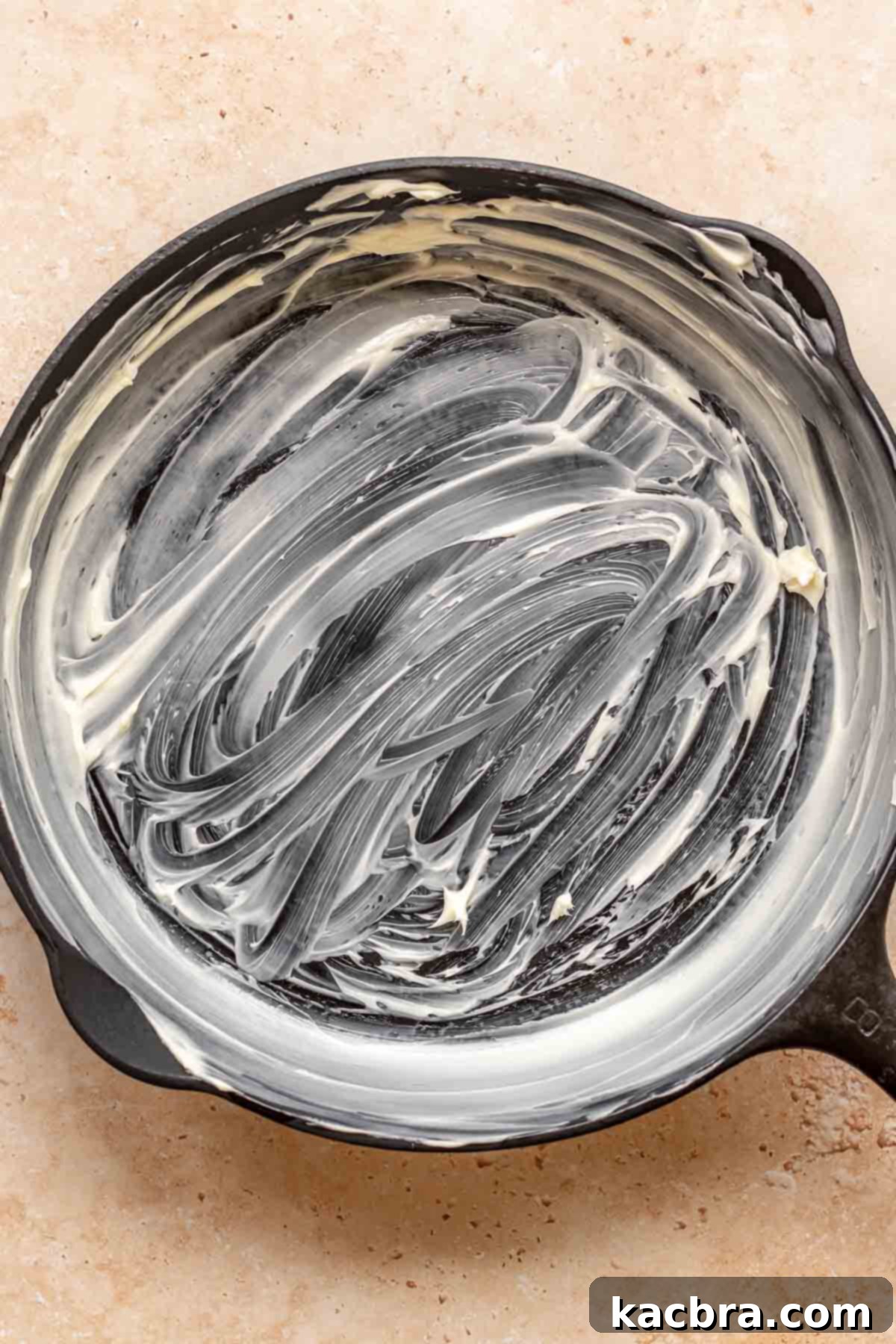 Golden Skillet Peach Cobbler 7 Cast iron skillet smeared with butter.