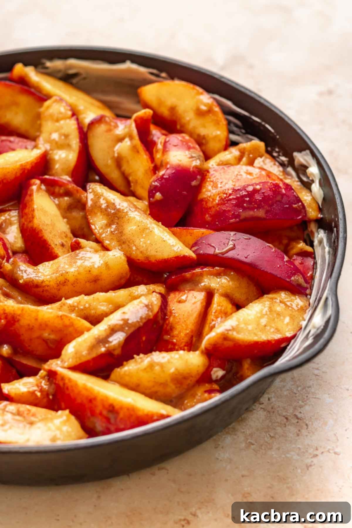 Golden Skillet Peach Cobbler 8 Spiced peach slices in a cast iron skillet.