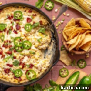 Kickin' Jalapeño Corn Dip 13 Jalapeno corn dip in a skillet with a spoon and chips on the side.