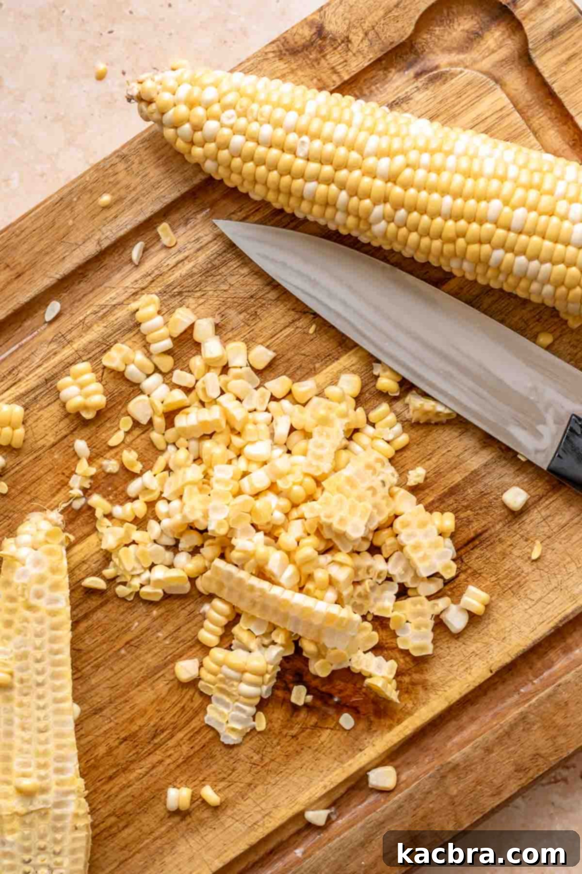 Kickin' Jalapeño Corn Dip 5 Corn sliced off the cob on a cutting board.