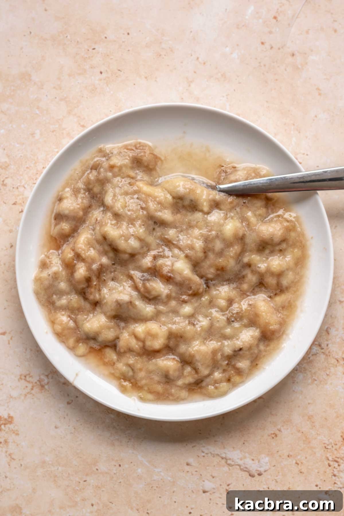 Sweet and Healthy Banana Blueberry Oatmeal Muffins 4 Mashed ripe bananas in a bowl.