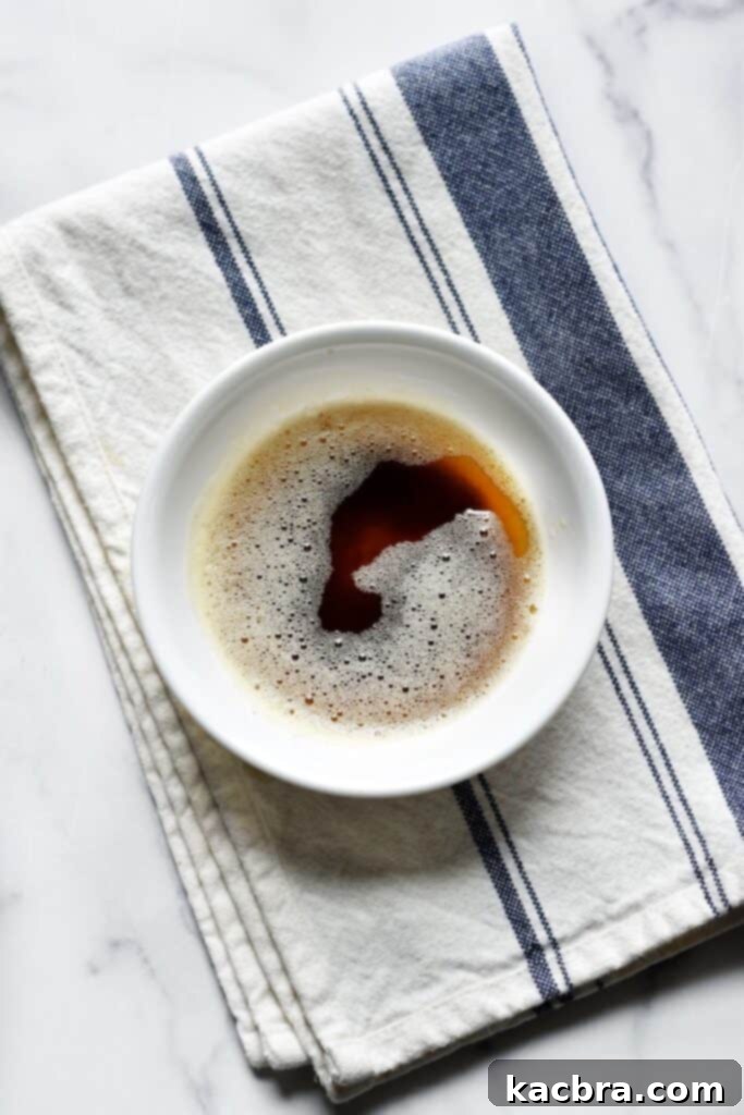 Overhead photo of deep brown butter in a bowl, in liquid form.