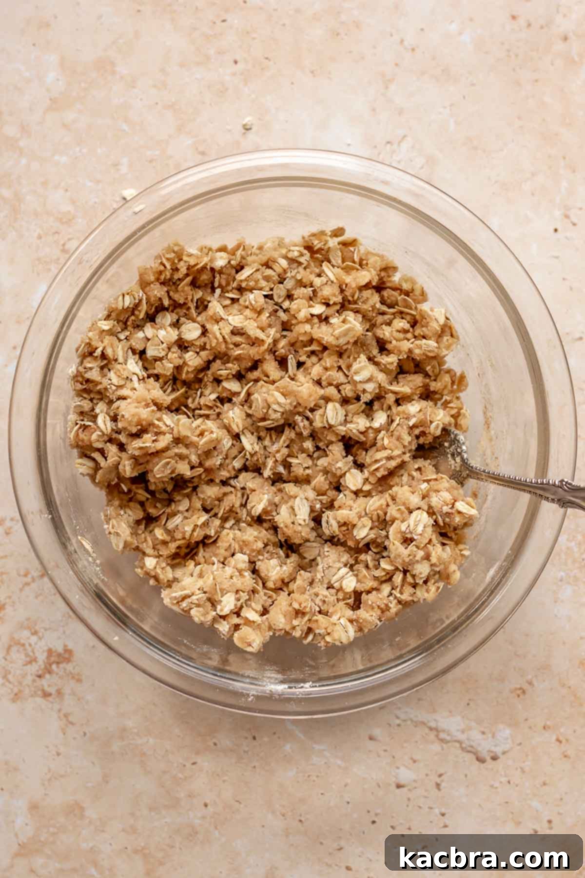 Streusel topping in a bowl with a fork, showing the crumbly texture.