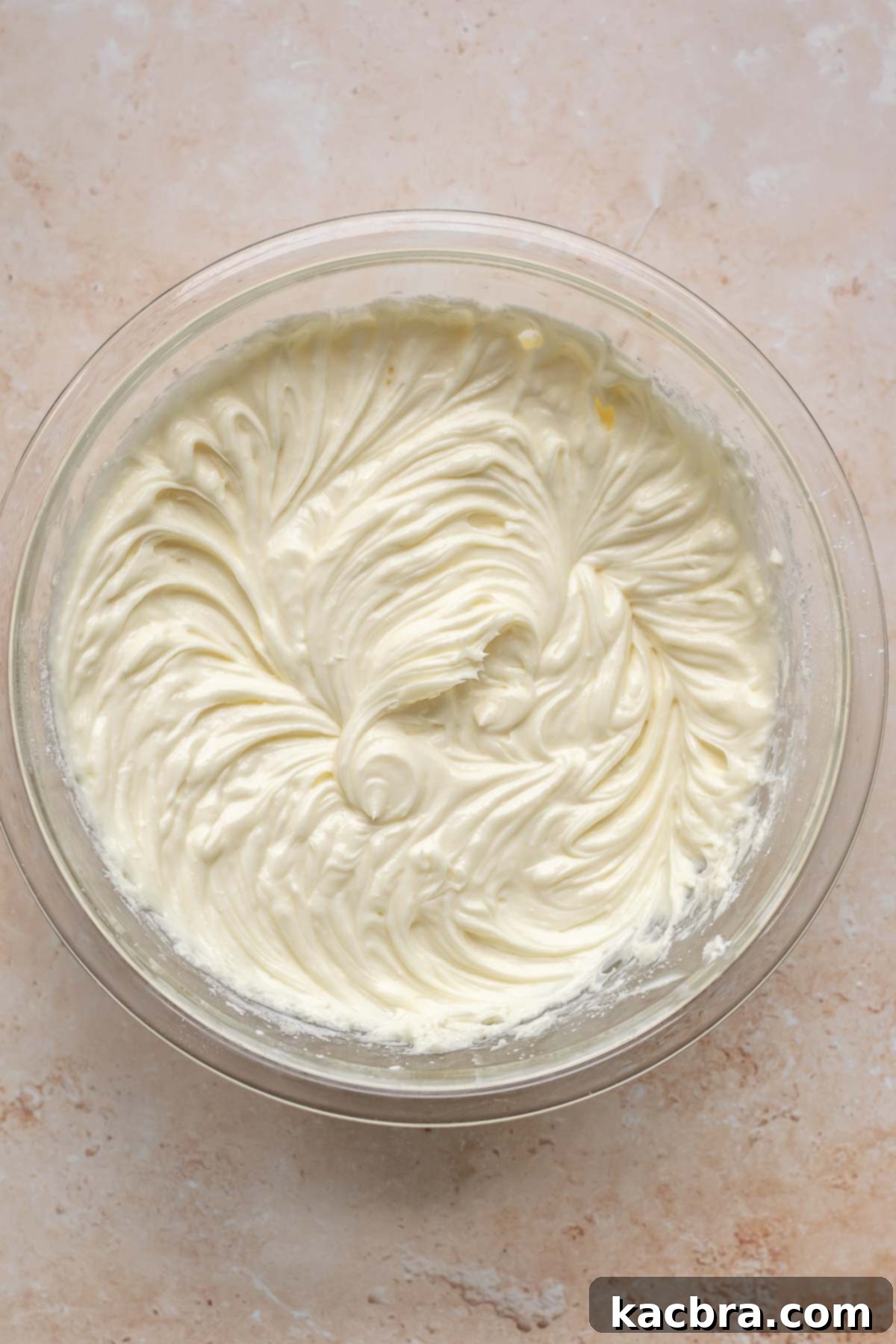 Cream cheese batter whisked in a mixing bowl.