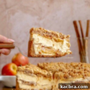 A hand holds a piece of apple cheesecake on a pie server.