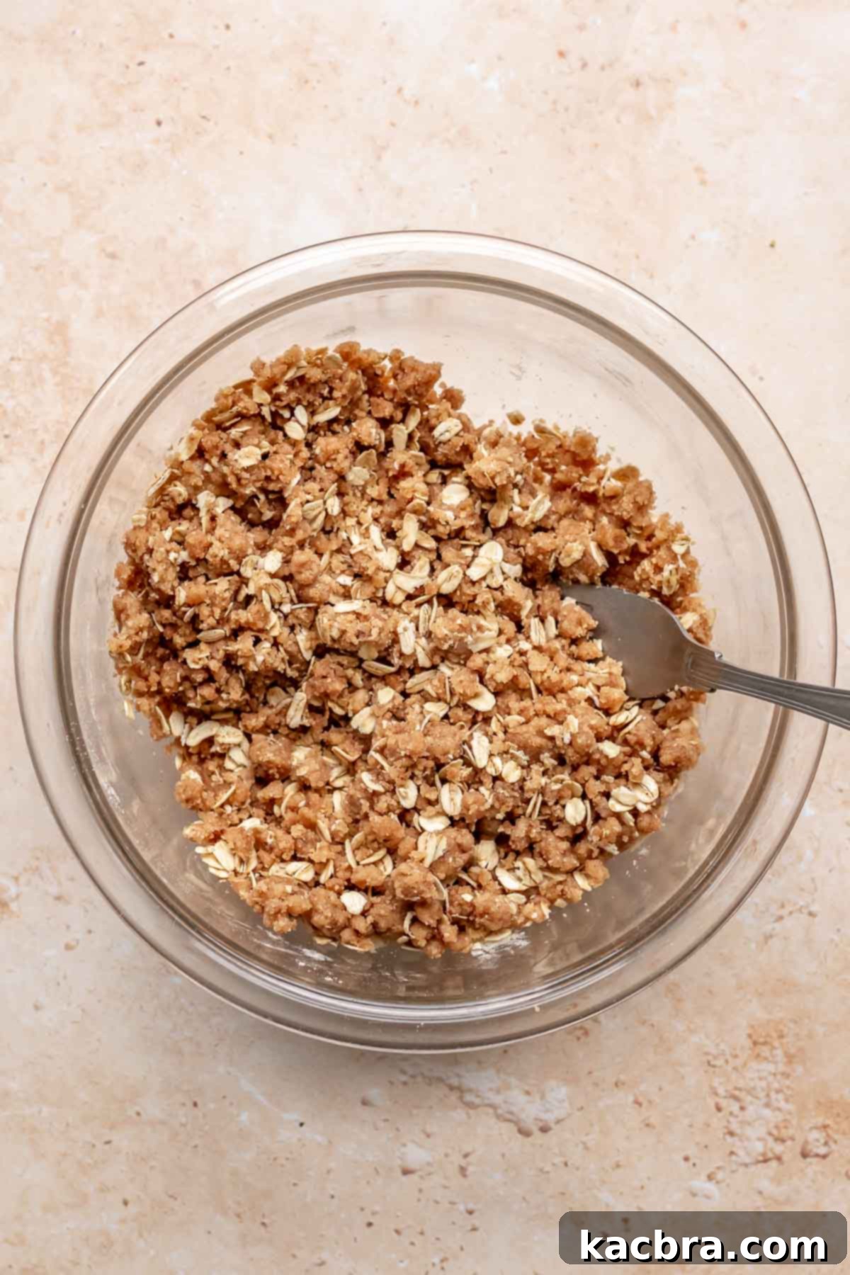 Crumble topping mixed in a bowl with a fork.