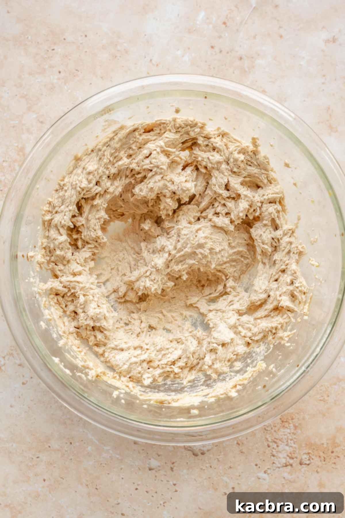 Smooth, emulsified cookie dough in a mixing bowl, showcasing the consistency after adding the egg and vanilla.