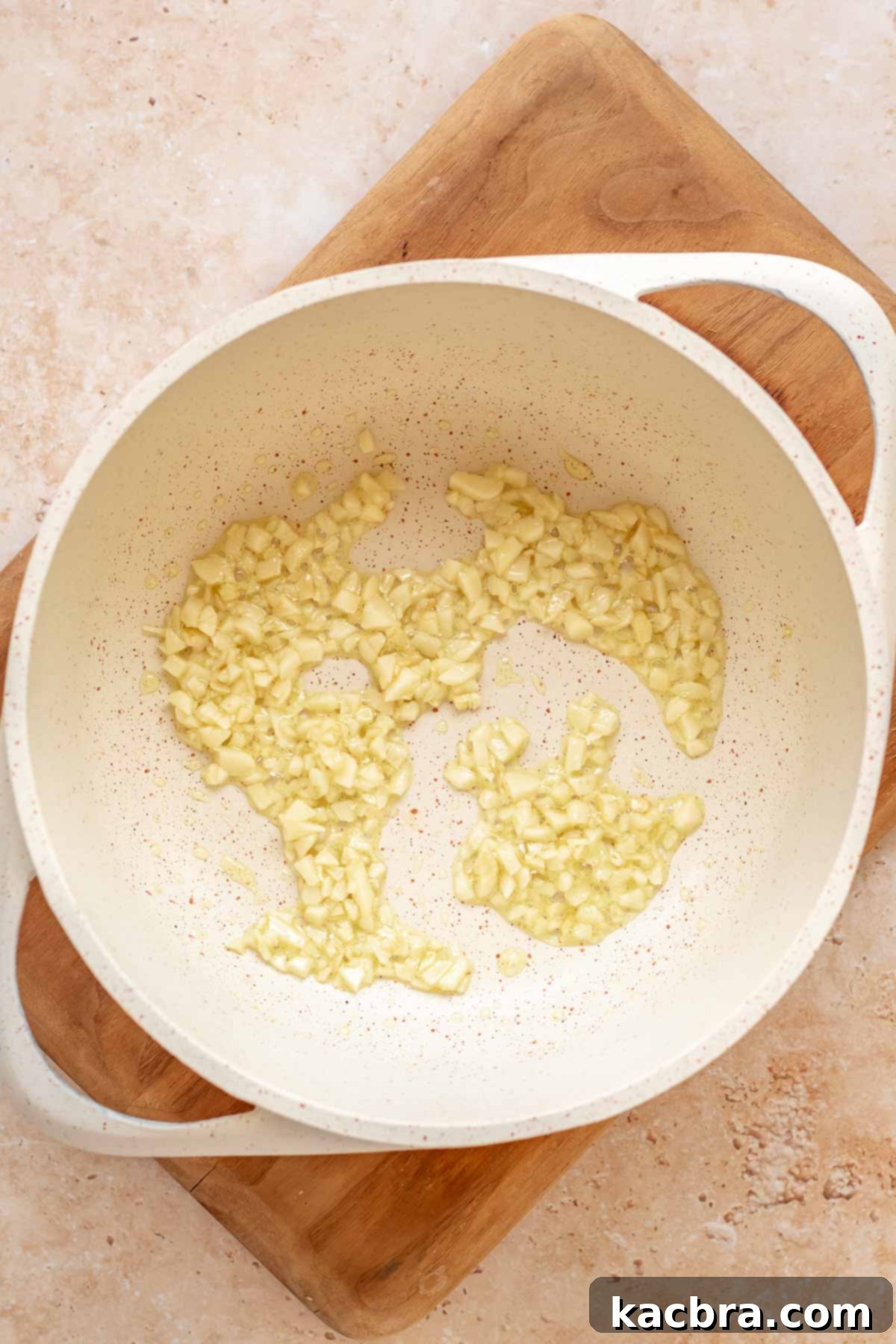 Garlic sautéing in a saucepan.