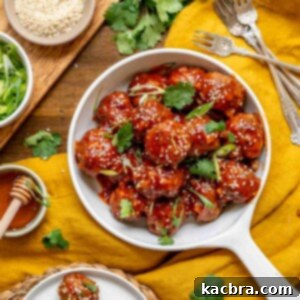 A bowl of honey sriracha meatballs with garnishes surrounding the bowl.