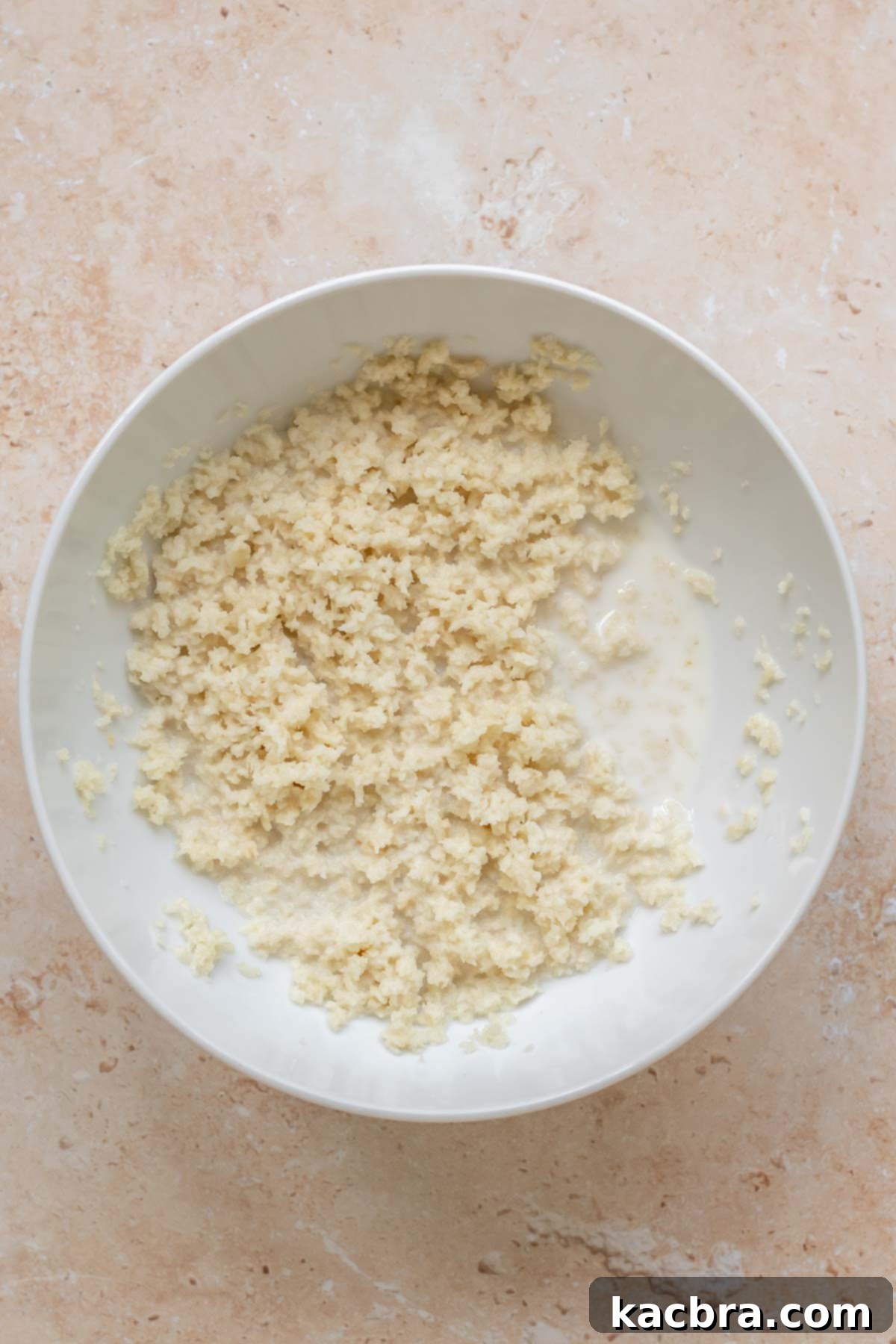 Panko bread crumbs and milk in a bowl.