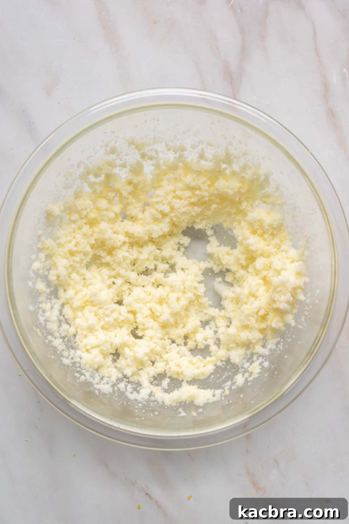 Creaming butter and sugar together in a mixing bowl until light and fluffy.