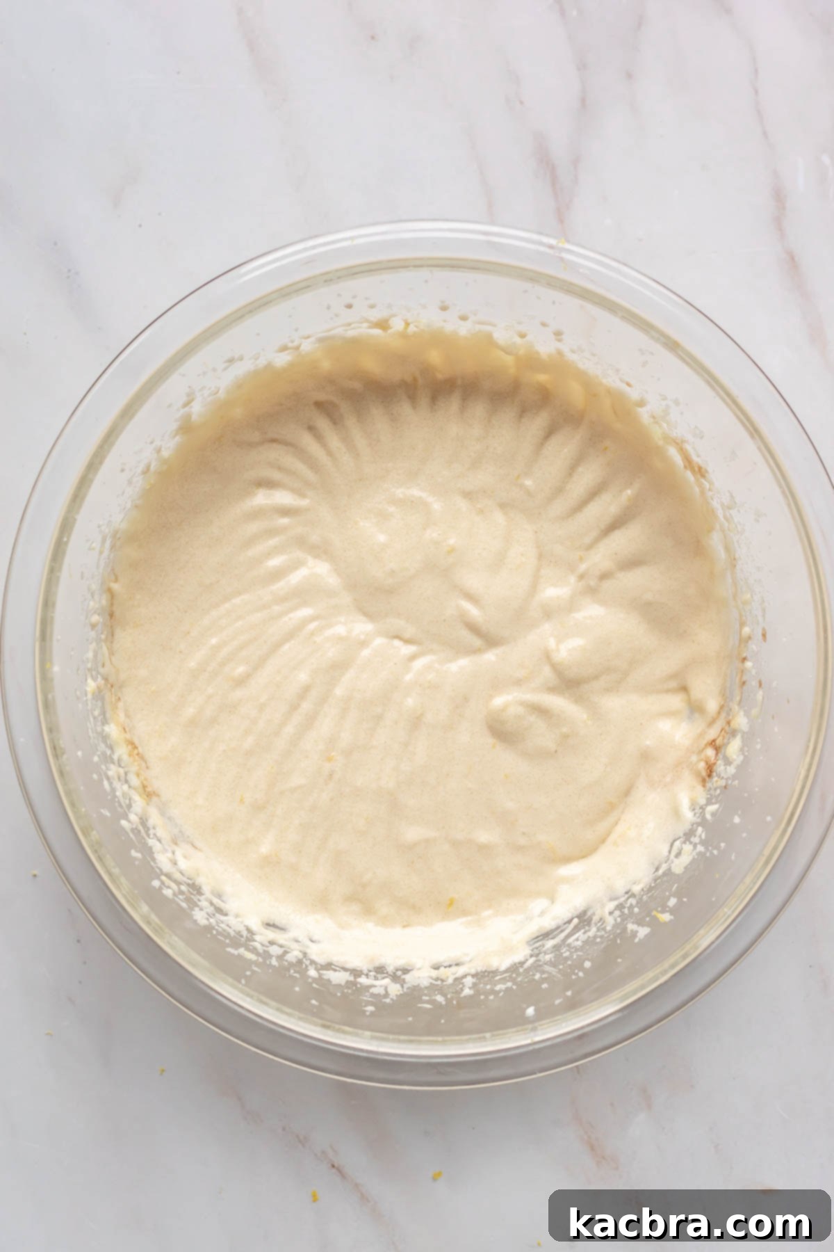 Mixing sour cream and vanilla extract into the wet cake ingredients.