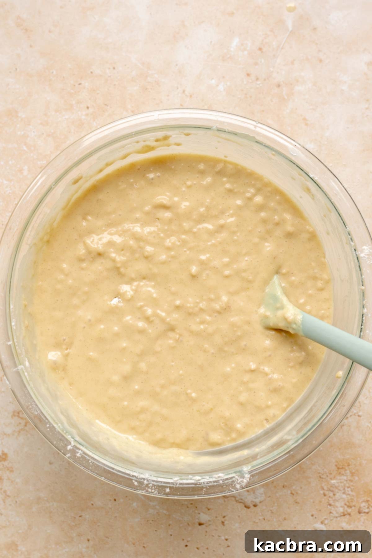 Finished vanilla muffin batter in a bowl, showing a slightly lumpy texture.