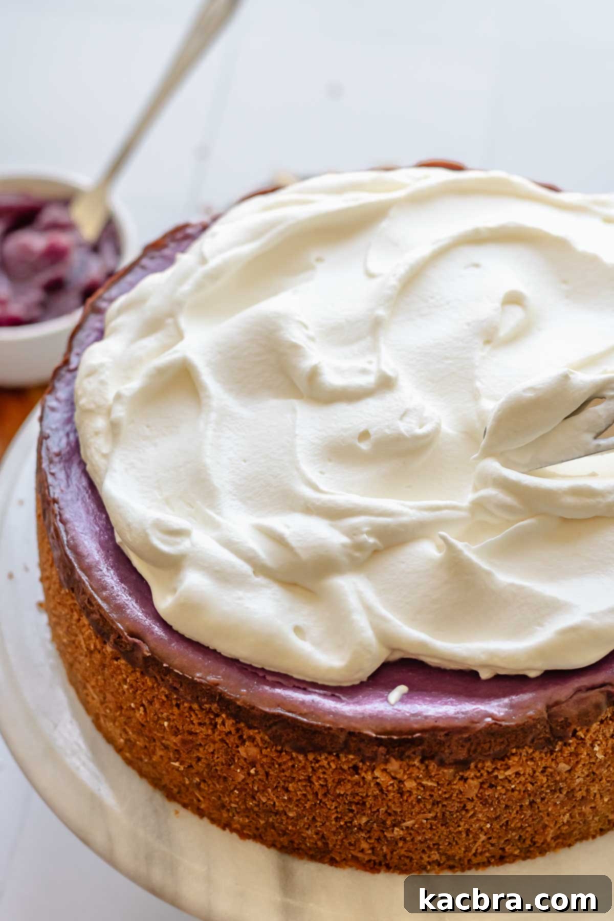 Coconut whipped cream spread on top of use cheesecake.