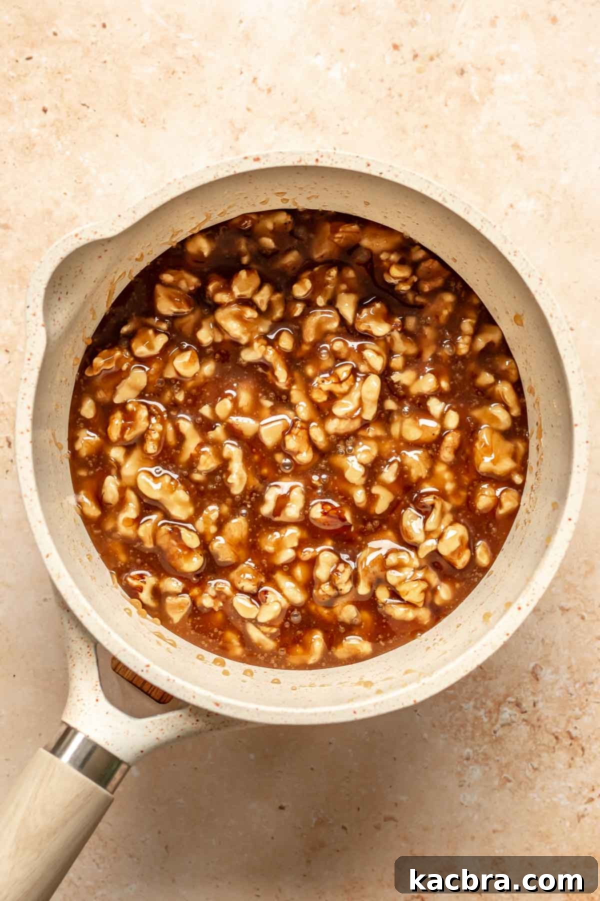 Decadent Chocolate Walnut Dream 12 Roughly chopped pecans (walnuts in this recipe) mixed into caramel sauce in a pot, creating the rich, nutty filling.