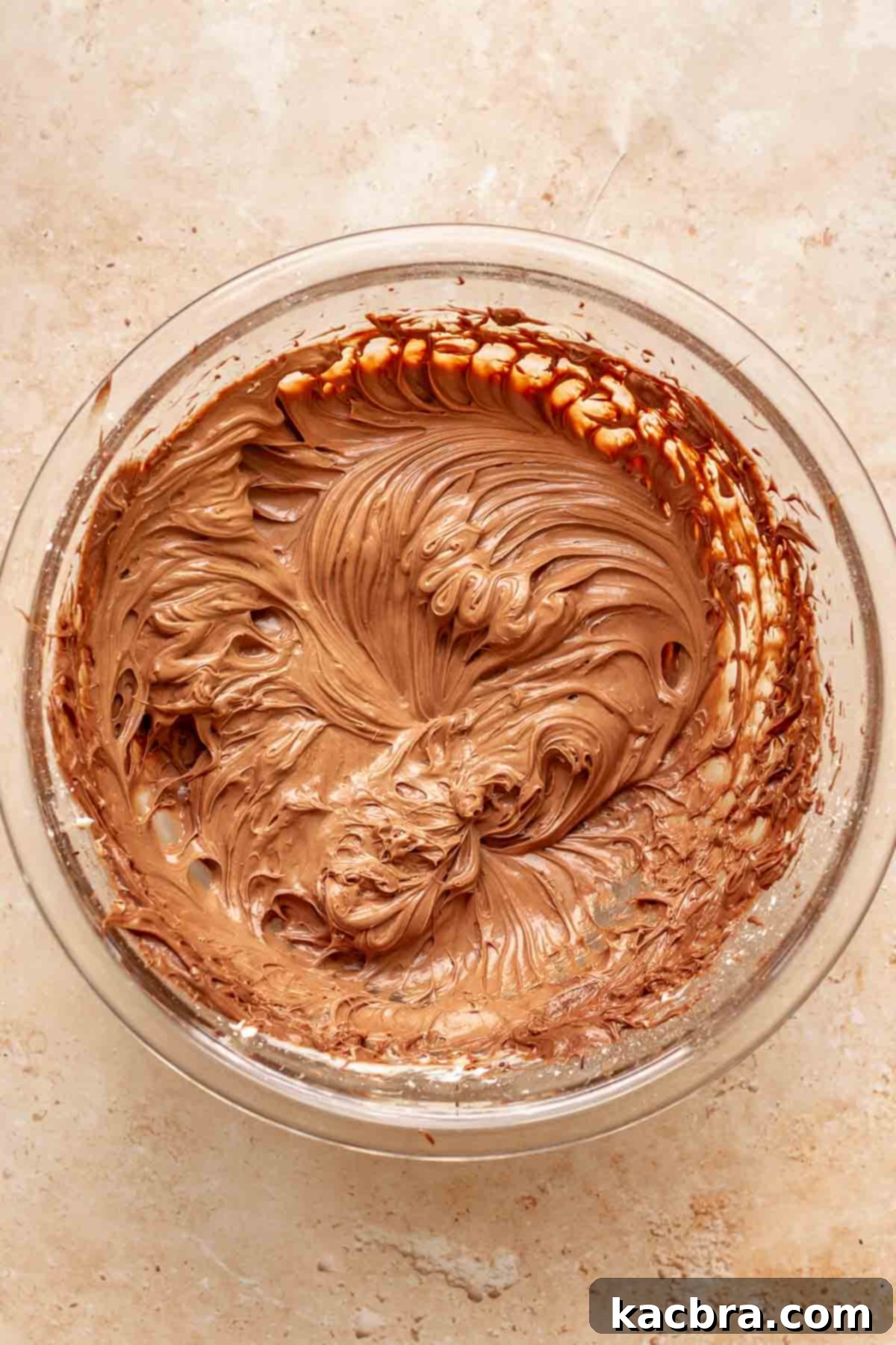 Chocolate cream cheese frosting whipped in a bowl.