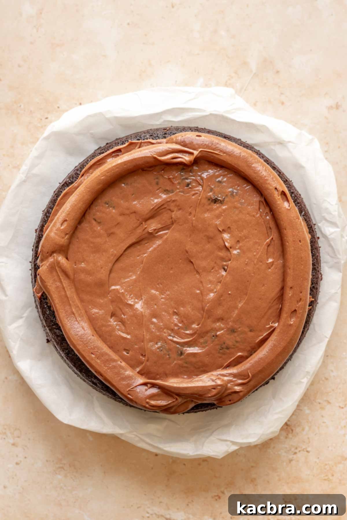 A frosting dam rims the cake.