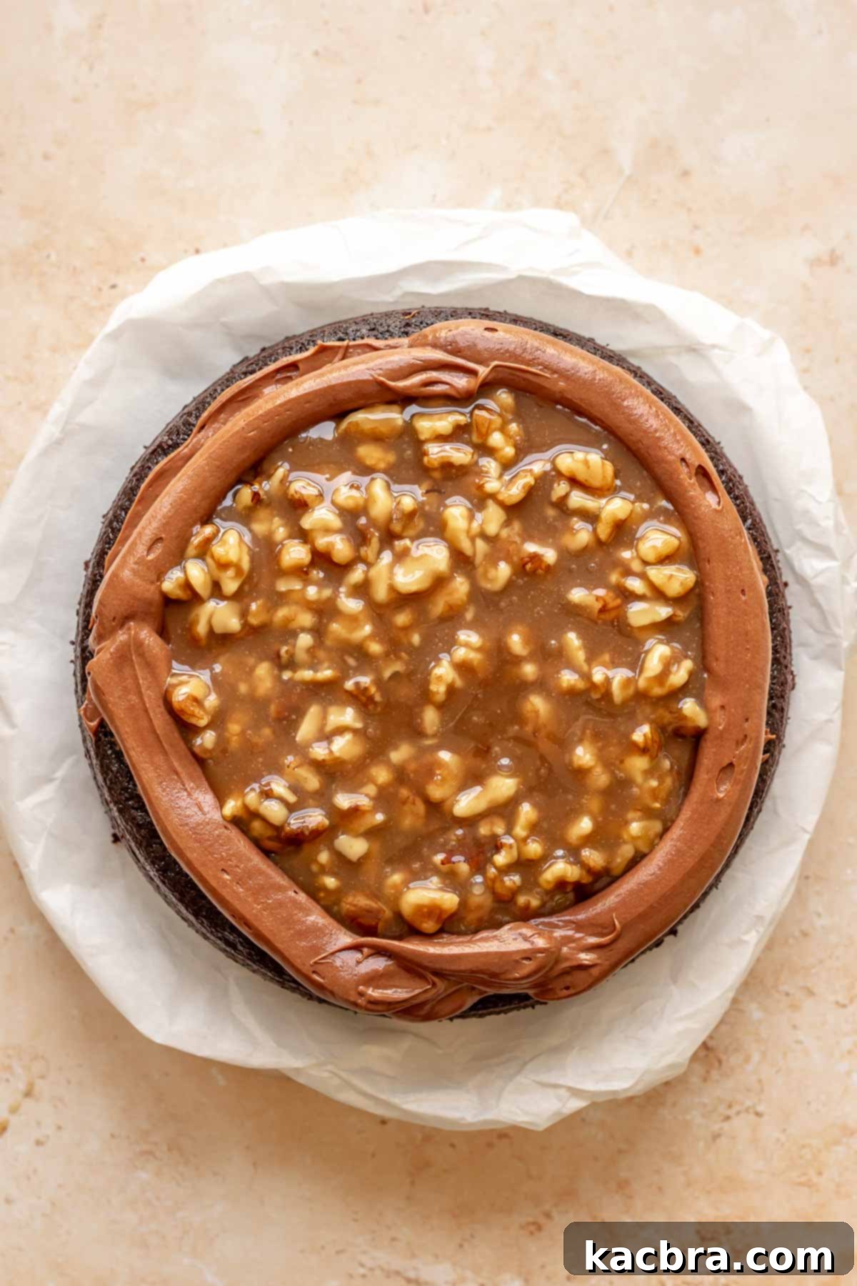 Caramel walnut filling is added to the cake.