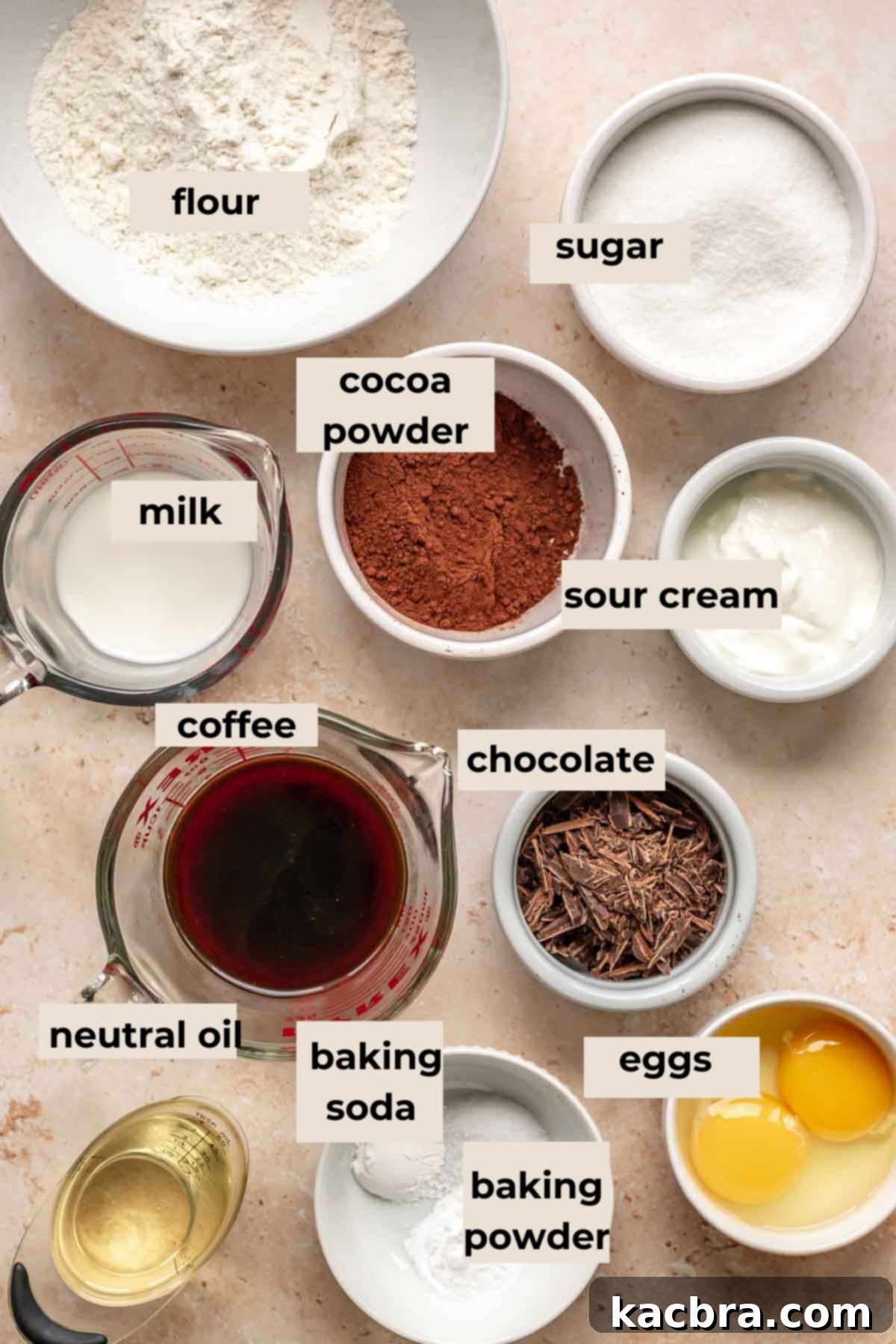 Decadent Chocolate Walnut Dream 3 A collection of dry and wet ingredients for the chocolate cake base, including flour, sugar, cocoa powder, eggs, milk, and oil, neatly arranged on a counter.