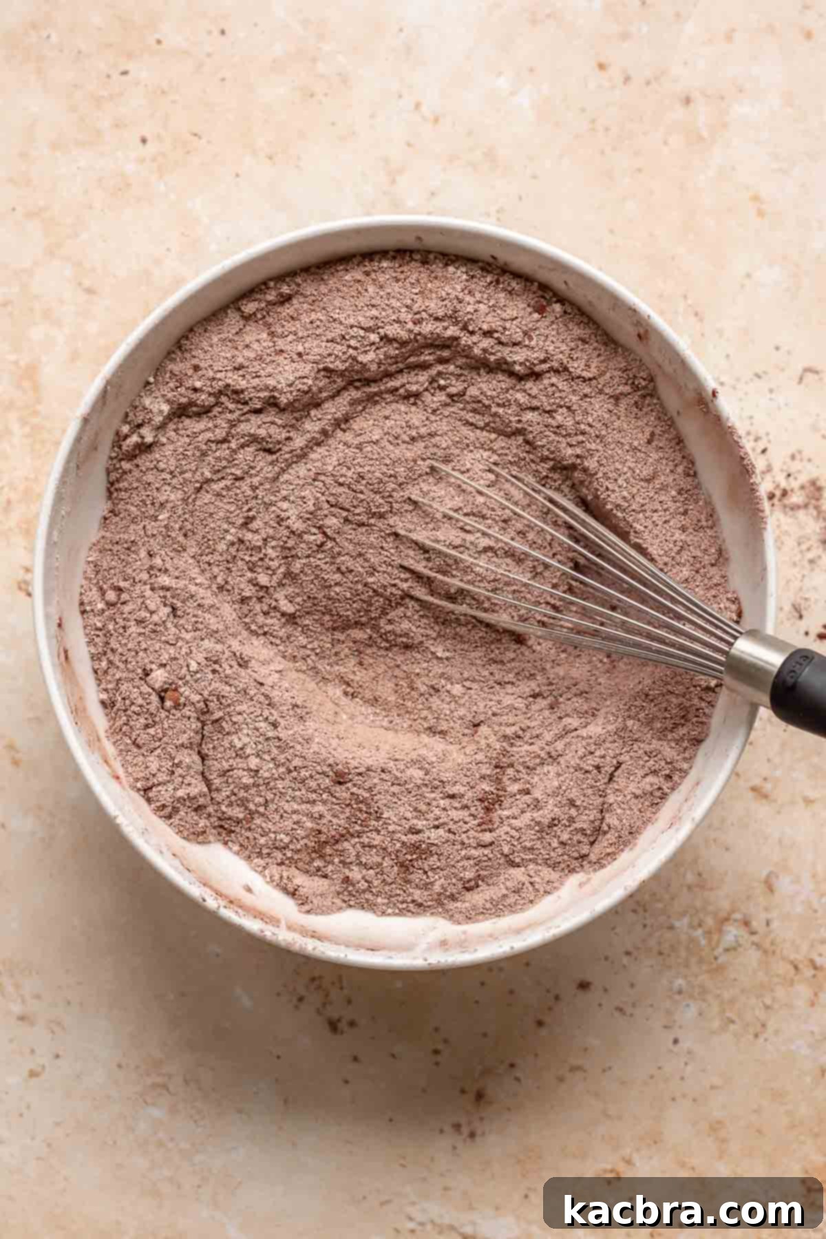 Decadent Chocolate Walnut Dream 5 Dry chocolate cake ingredients, including flour, cocoa powder, sugar, baking soda, and baking powder, whisked together in a large mixing bowl.