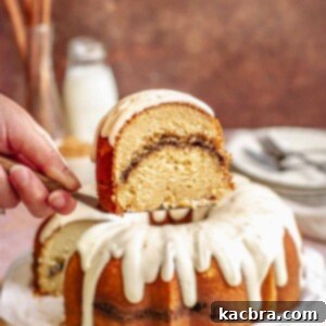A slice of cinnamon bundt cake being held up on a spatula.