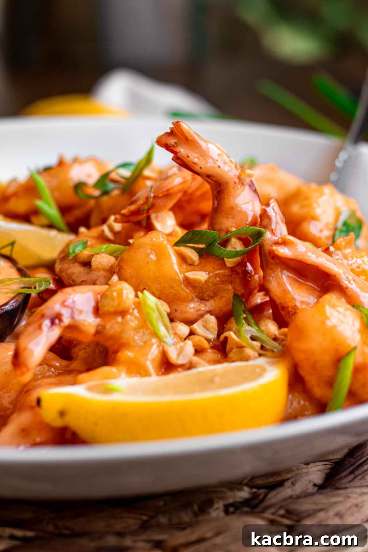 Boom boom shrimp plated on a platter with lemon slices.