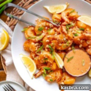 Boom boom shrimp on a platter with tongs.