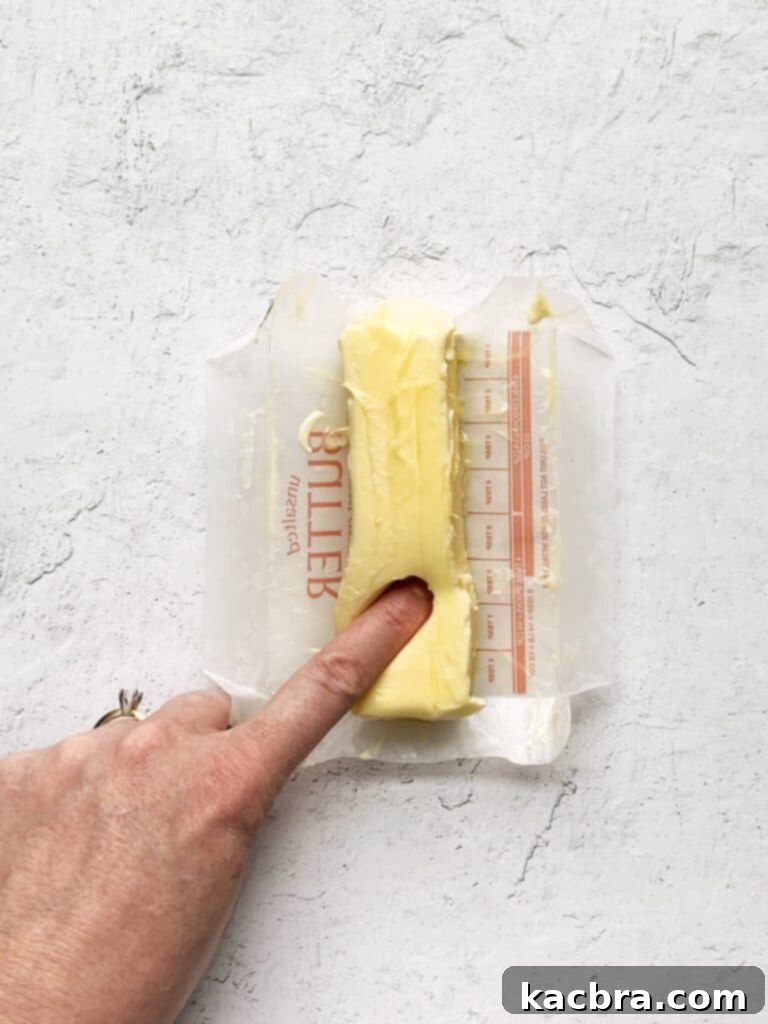 Decoding Room Temperature for Better Butter 6 Finger pushing deep into a stick of butter that is too soft