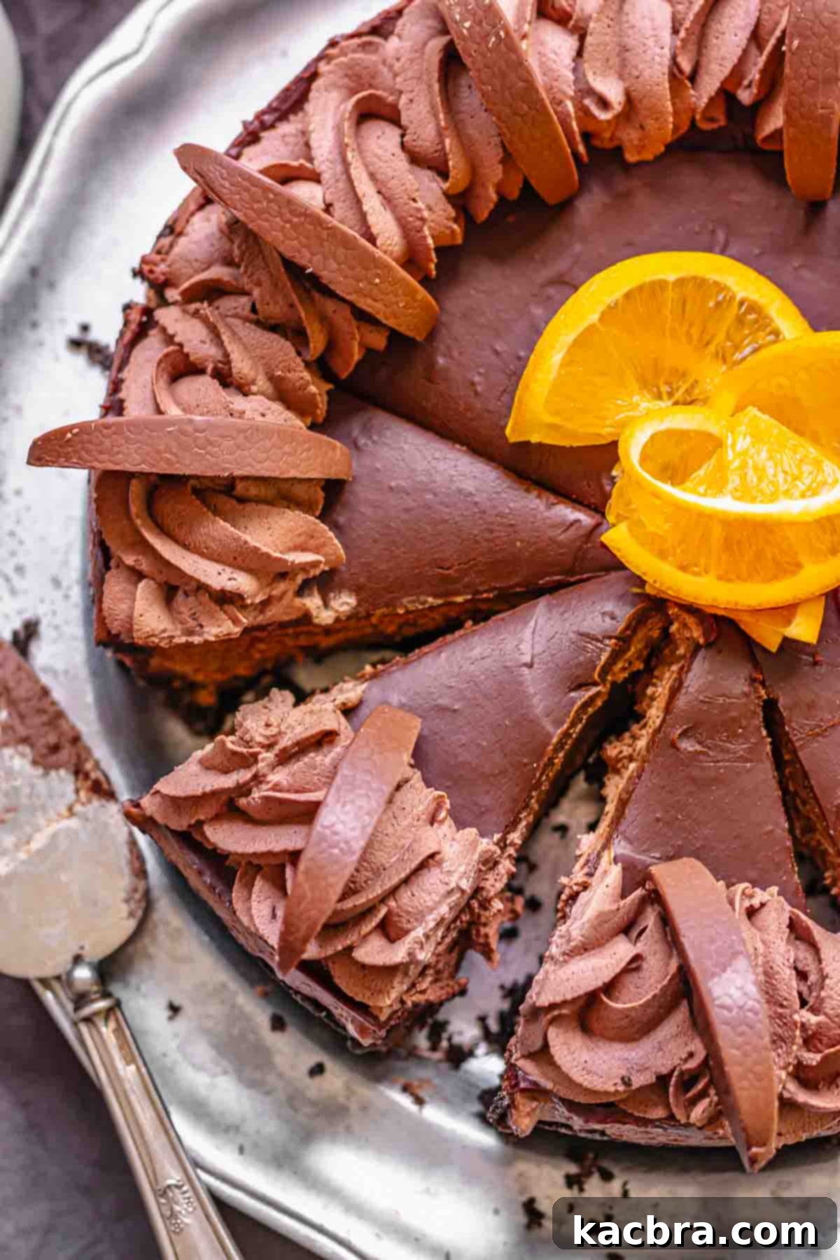 No-Bake Chocolate Orange Velvet Cheesecake 17 Sliced chocolate orange cheesecake on a platter.