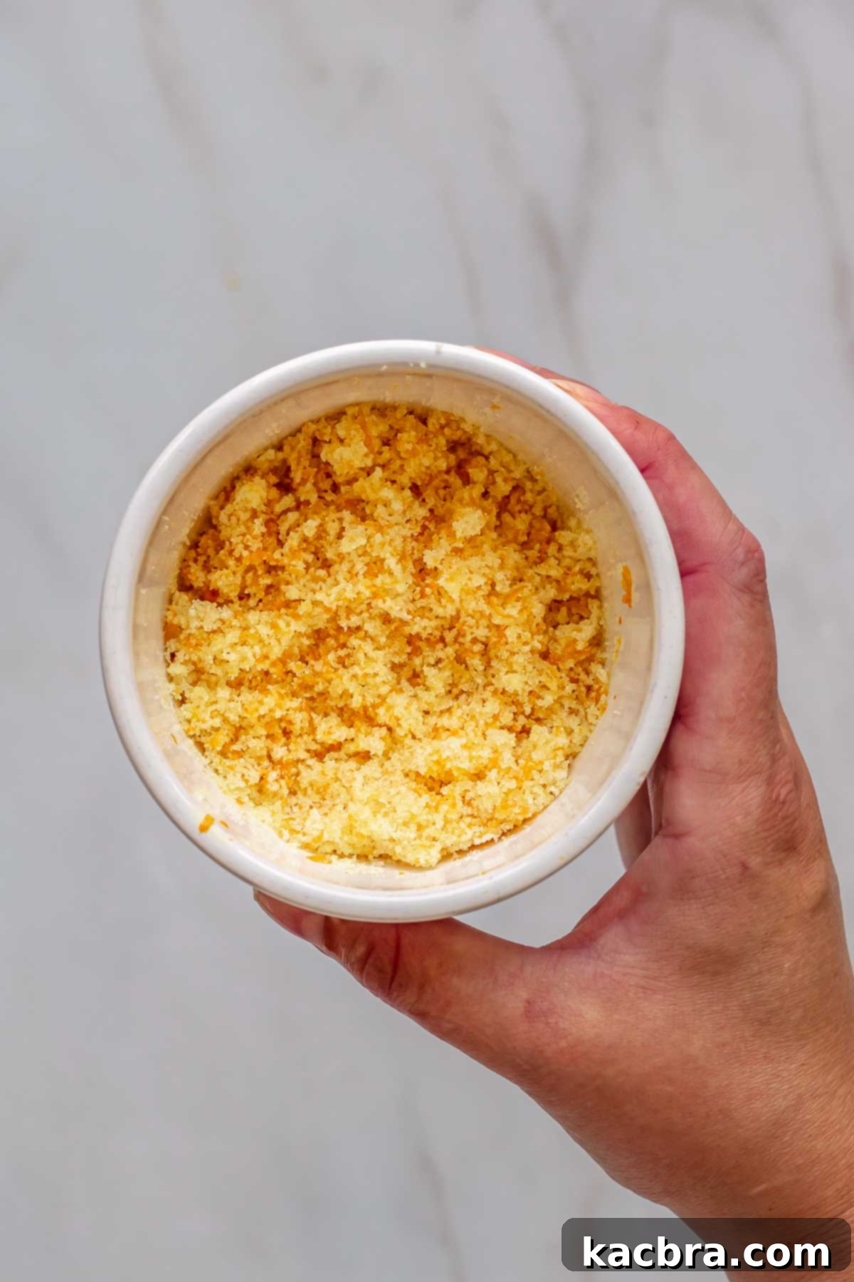 No-Bake Chocolate Orange Velvet Cheesecake 5 Orange zest and sugar mixed in a bowl.