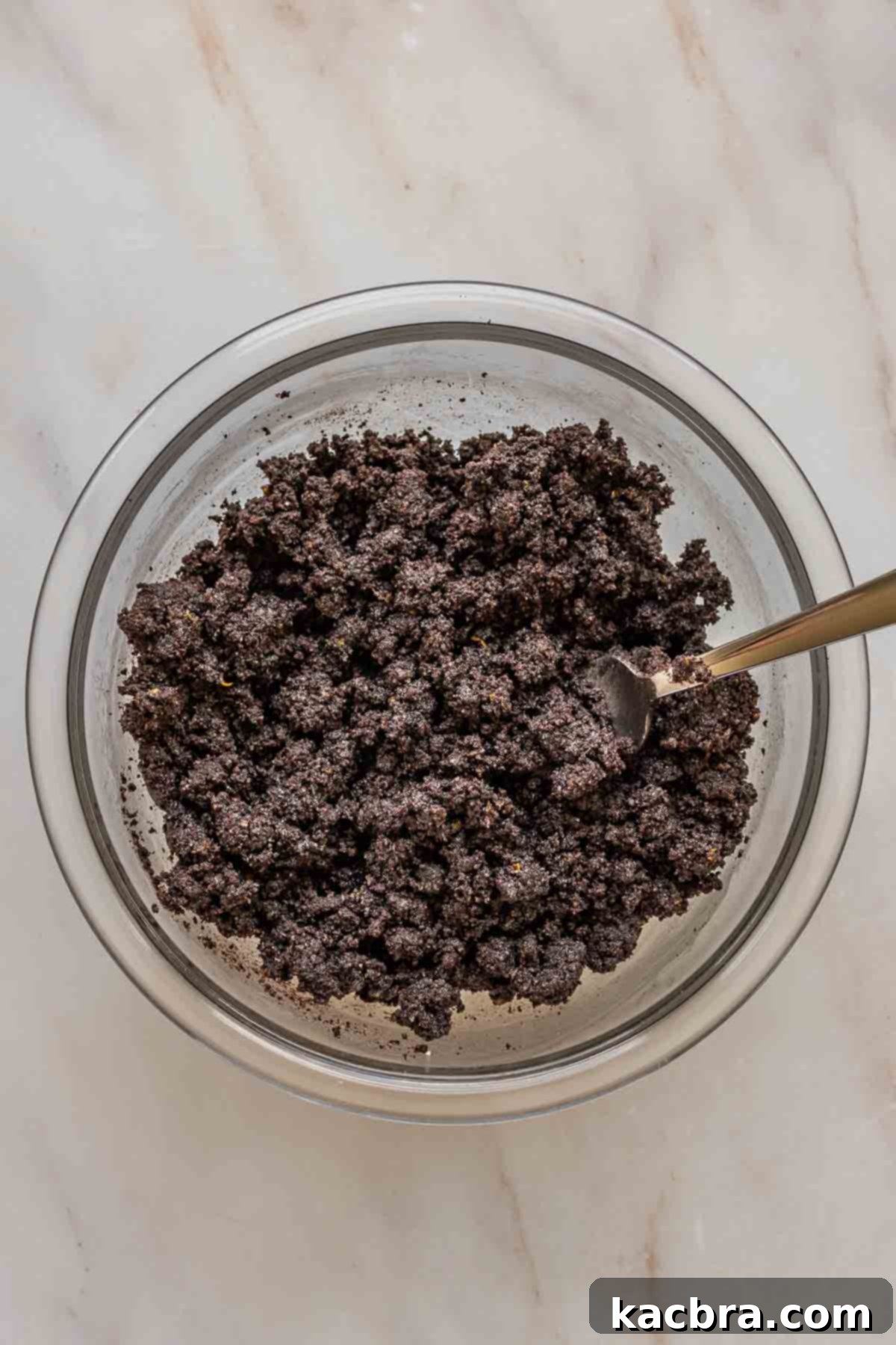 No-Bake Chocolate Orange Velvet Cheesecake 6 Oreo crumb crust in a bowl with a fork.