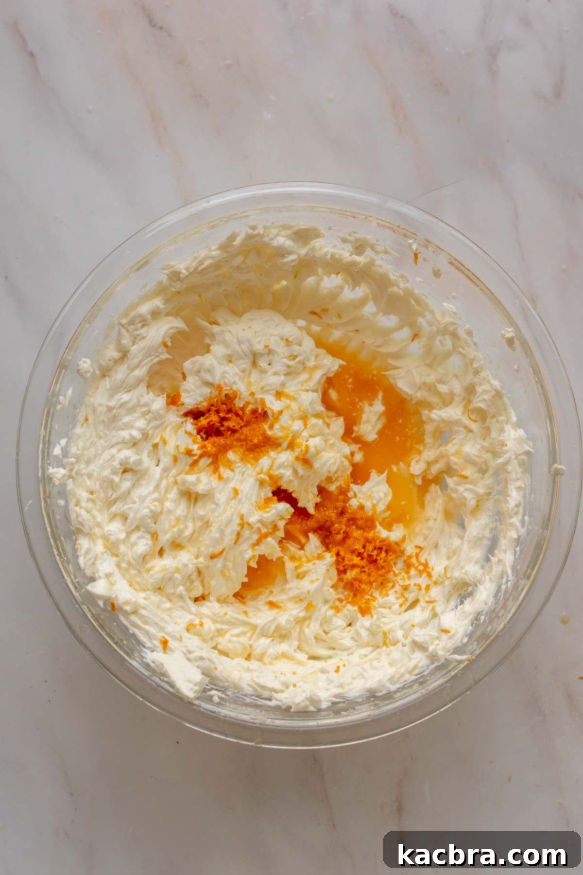 No-Bake Chocolate Orange Velvet Cheesecake 8 Cream cheese, orange zest, and orange juice in a bowl.