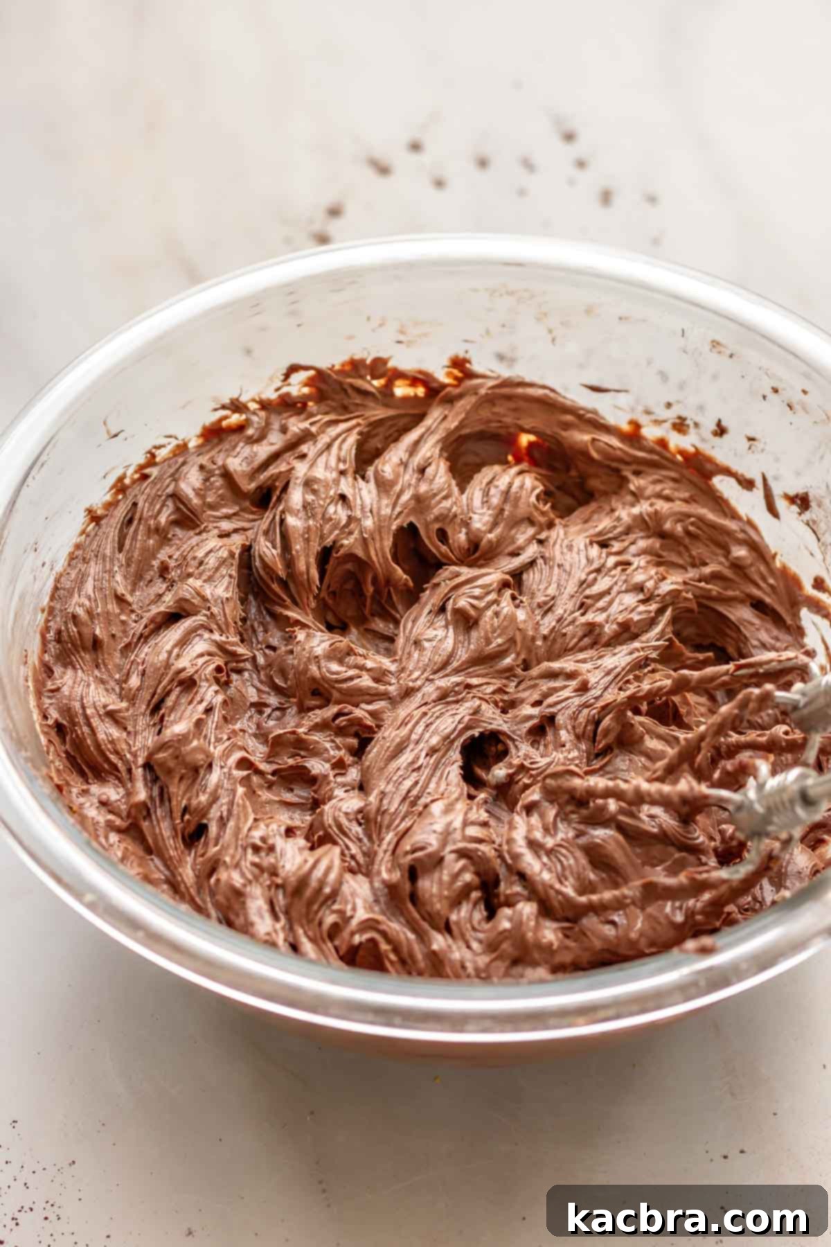 No-Bake Chocolate Orange Velvet Cheesecake 10 A hand mixer beats together chocolate cheesecake filling.